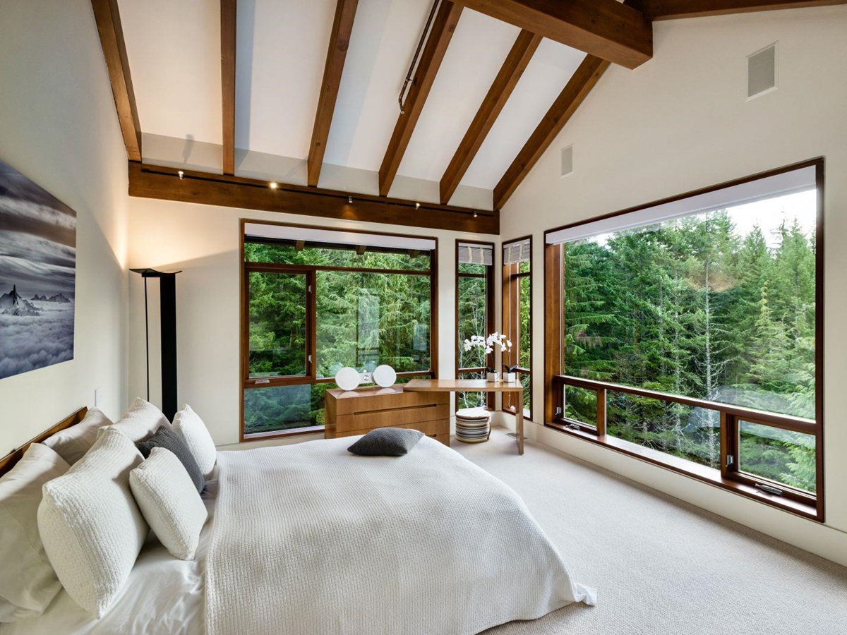 Double Bedroom with large windows overlooking the forest at luxury private home The Belmont Estate in Whistler, Canada