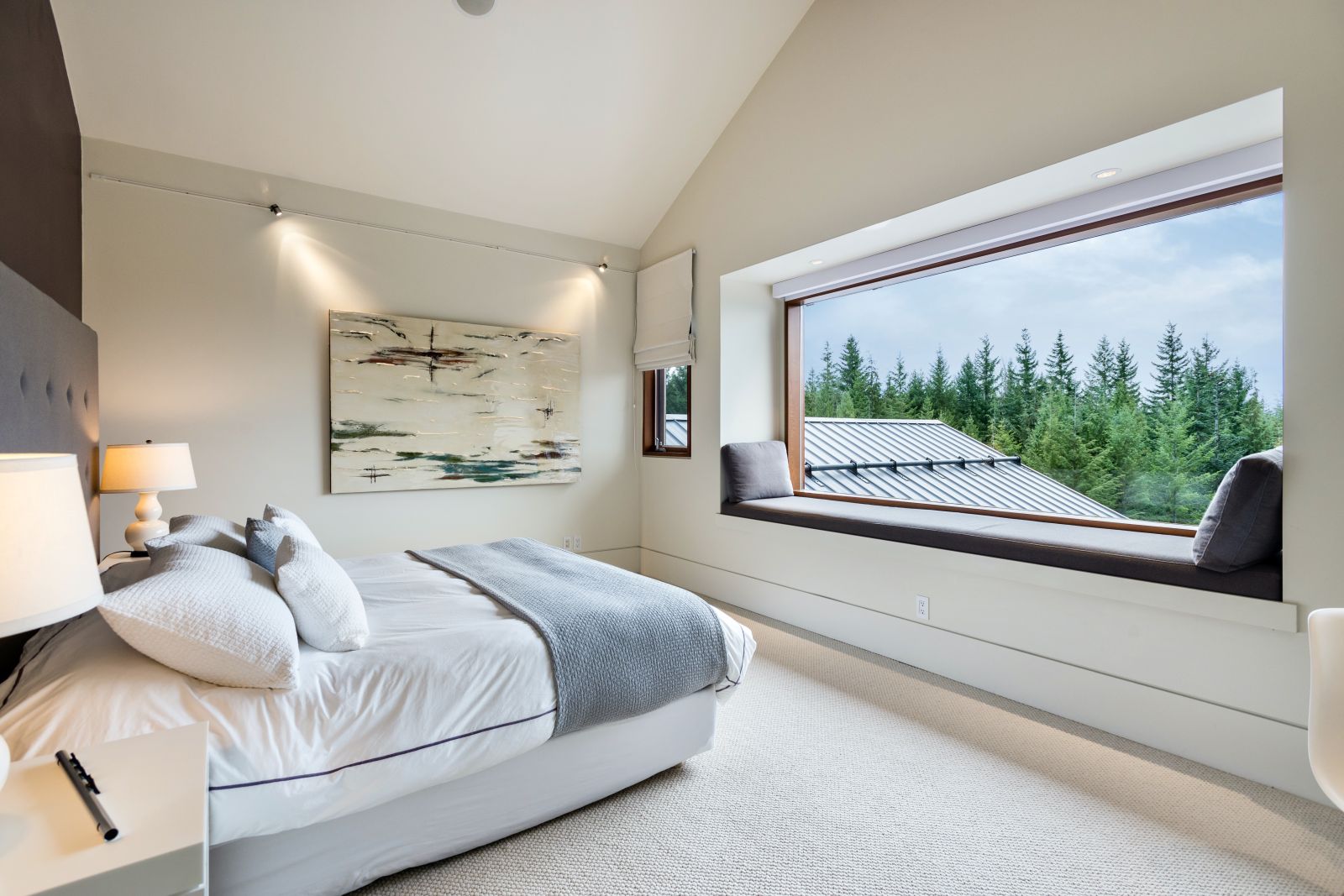 Double bedroom with large window overlooking the forest at luxury private home The Belmont Estate in Whistler, Canada