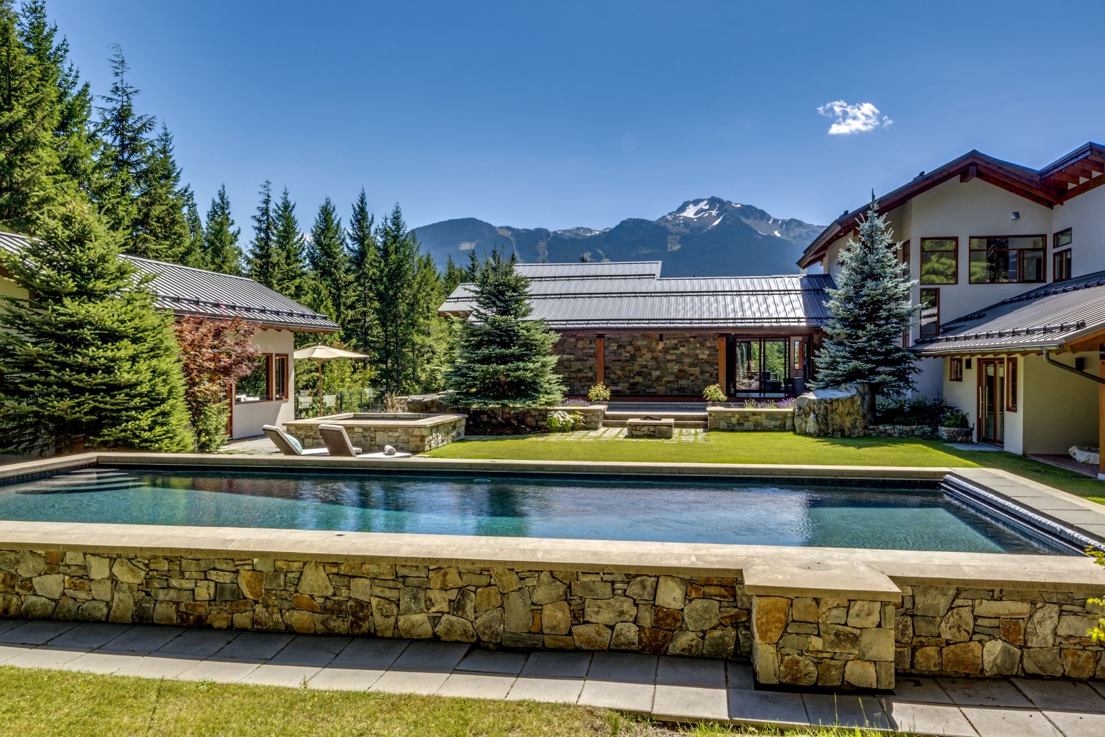 Pool and gardens of luxury private home The Belmont Estate in Whistler, Canada