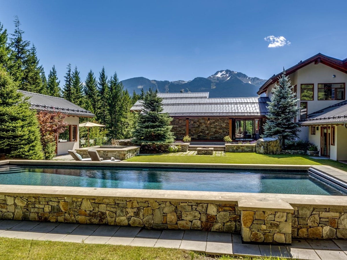 Pool and gardens of luxury private home The Belmont Estate in Whistler, Canada