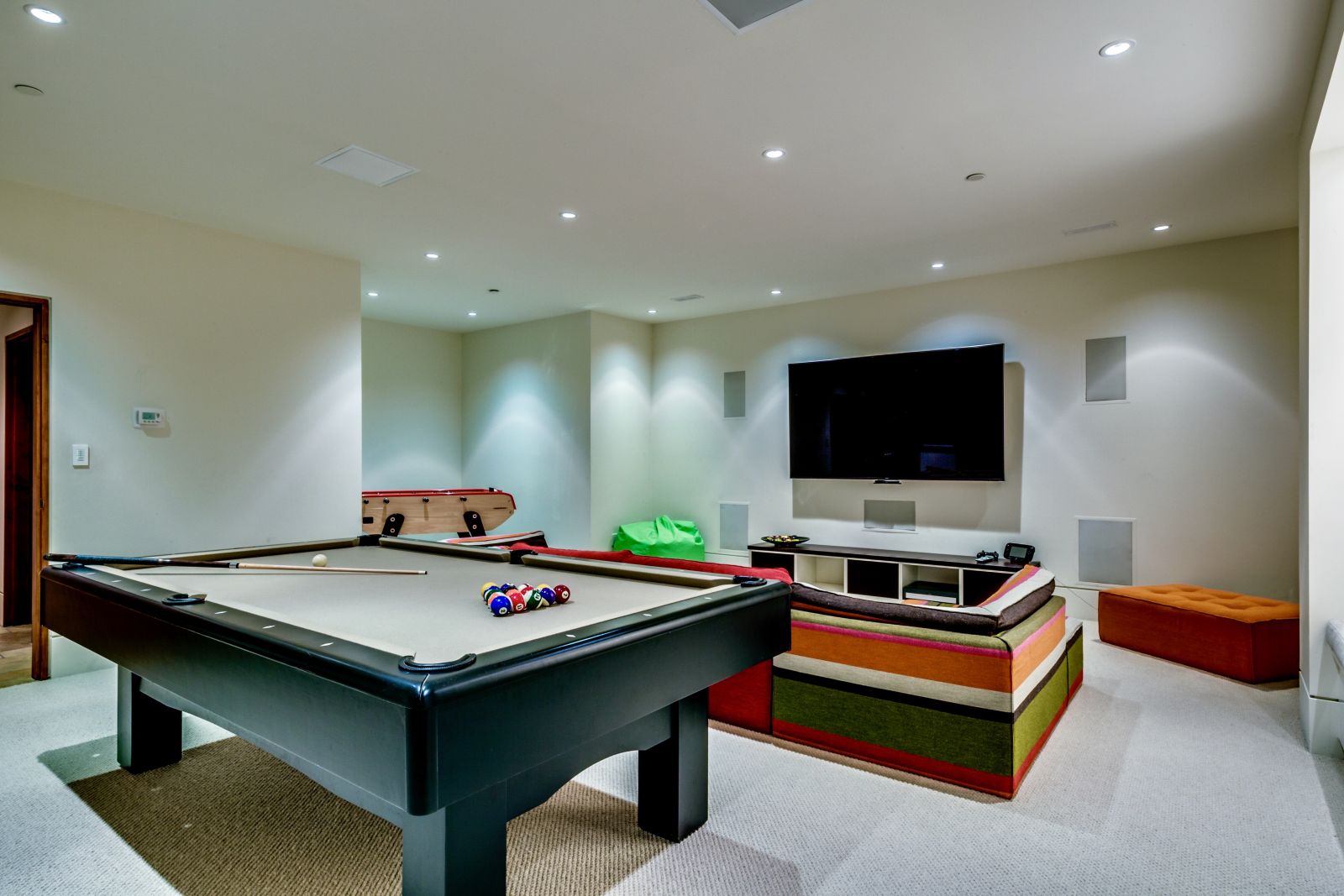 Games room with pool table and flat screen TV at luxury private home The Belmont Estate in Whistler, Canada