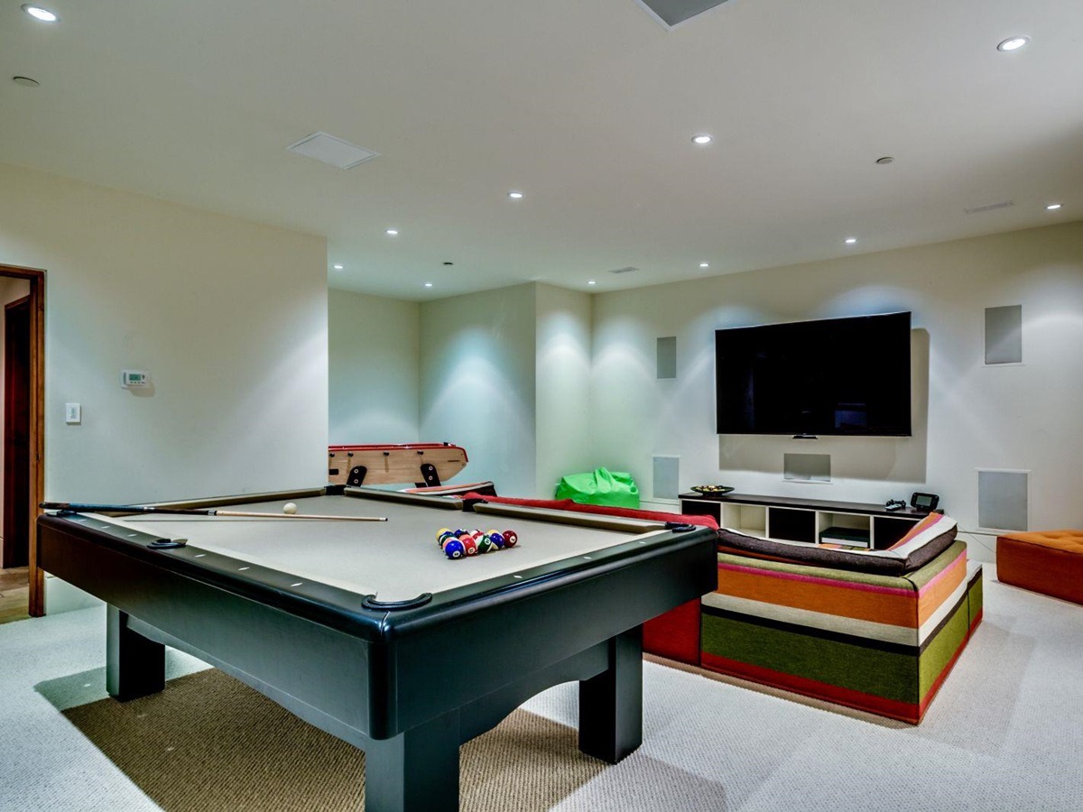 Games room with pool table and flat screen TV at luxury private home The Belmont Estate in Whistler, Canada