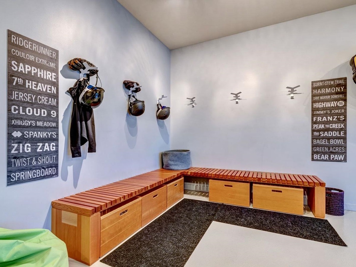 Cloakroom with storage for shoes and equipment and ample space on the walls for coats and jackets at luxury private home The Belmont Estate in Whistler, Canada