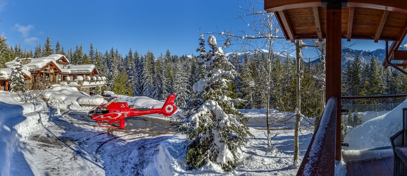 Helicopter landing in front of the snowy luxury villa Belmont Estate in Whistler, Canada