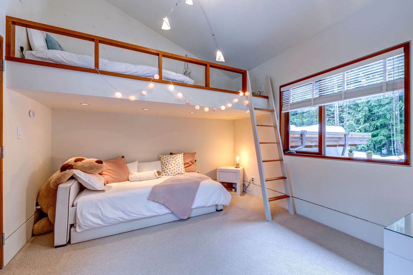 Kids's room with raised bed and views over the forest at luxury private home The Belmont Estate in Whistler, Canada