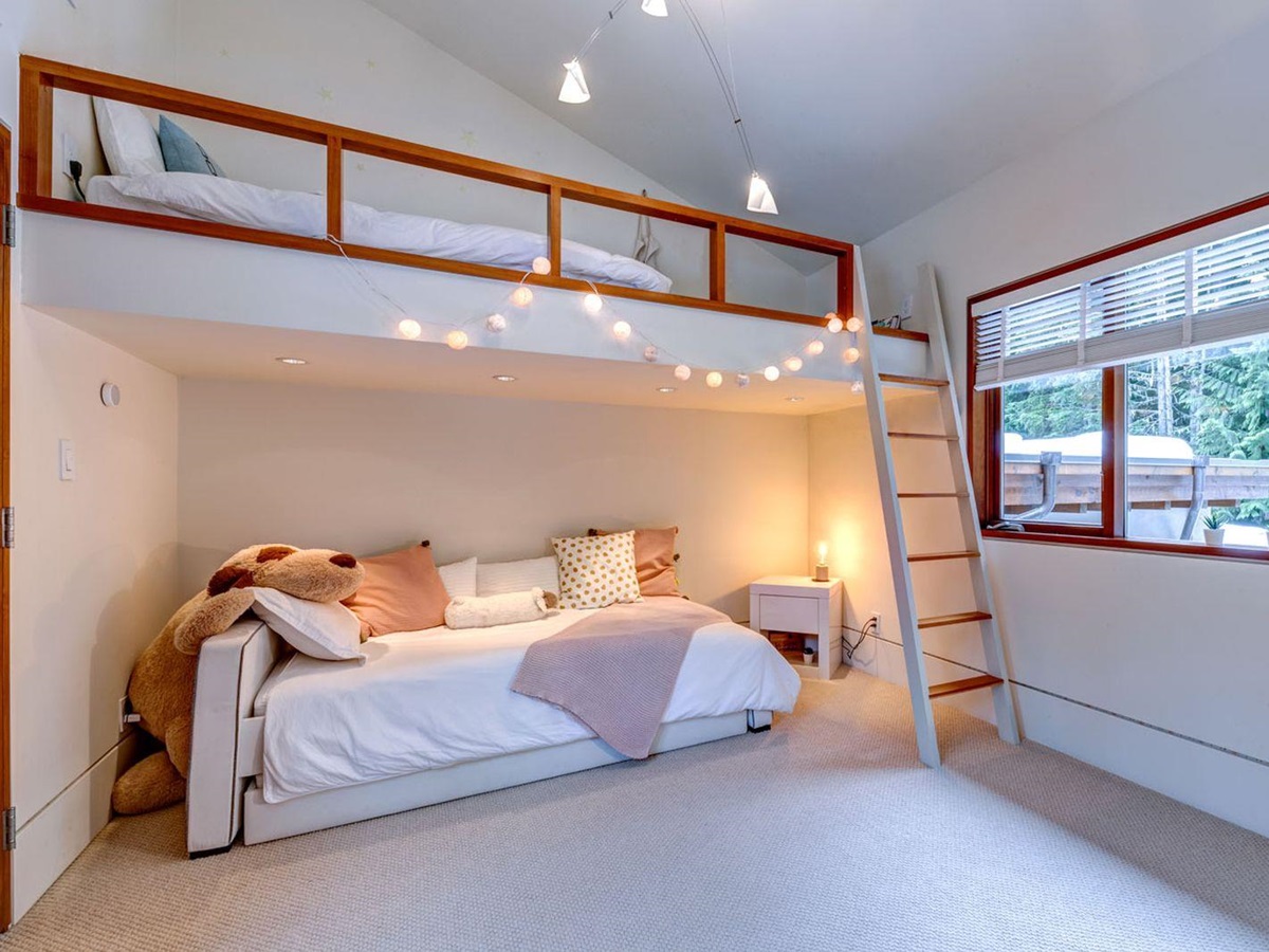 Kids's room with raised bed and views over the forest at luxury private home The Belmont Estate in Whistler, Canada
