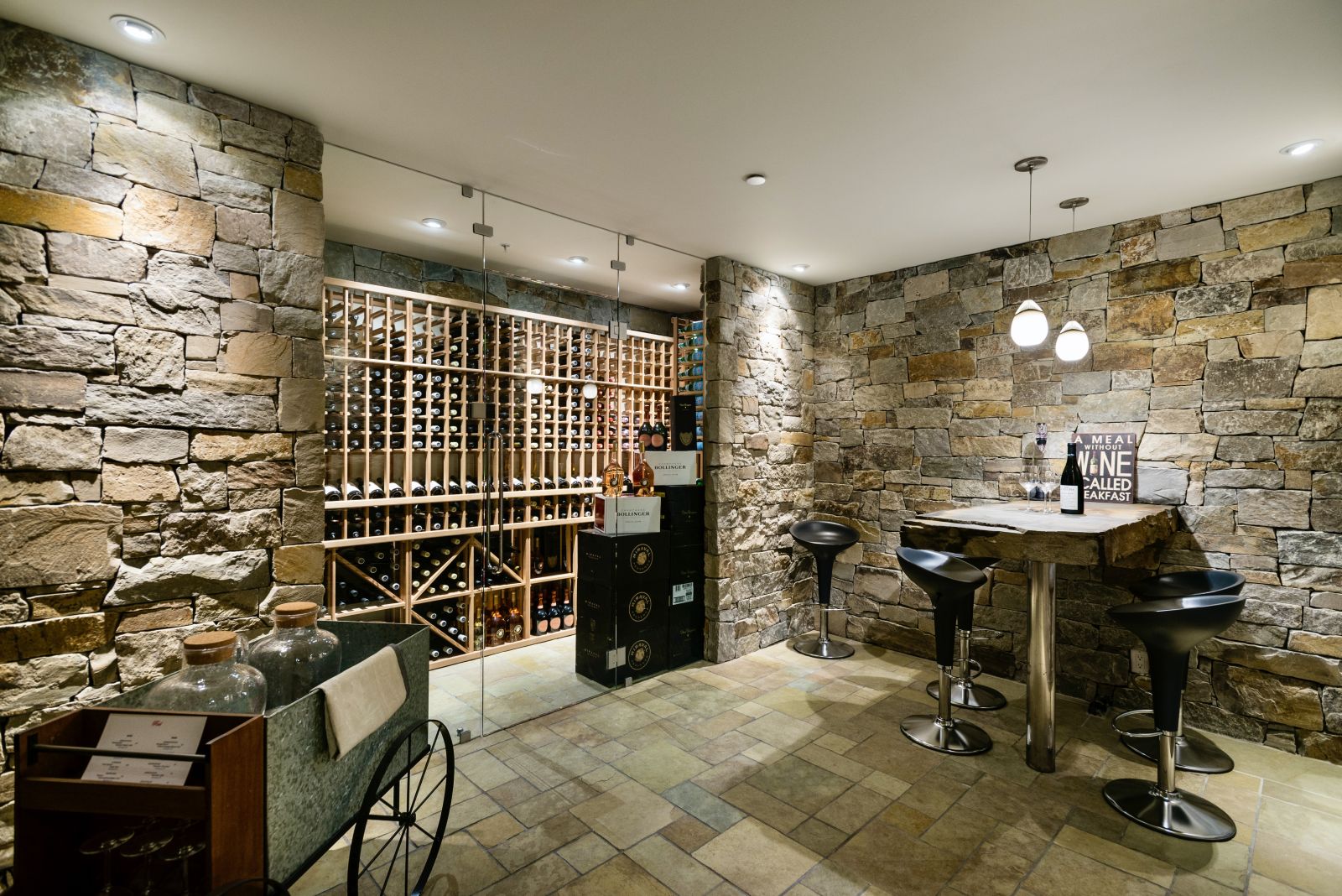 Well-stocked wine cellar with bar area at luxury private home The Belmont Estate in Whistler, Canada