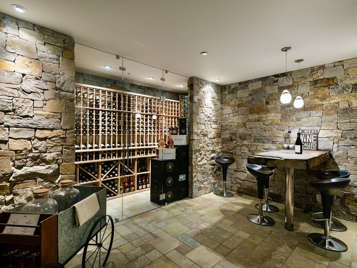 Well-stocked wine cellar with bar area at luxury private home The Belmont Estate in Whistler, Canada