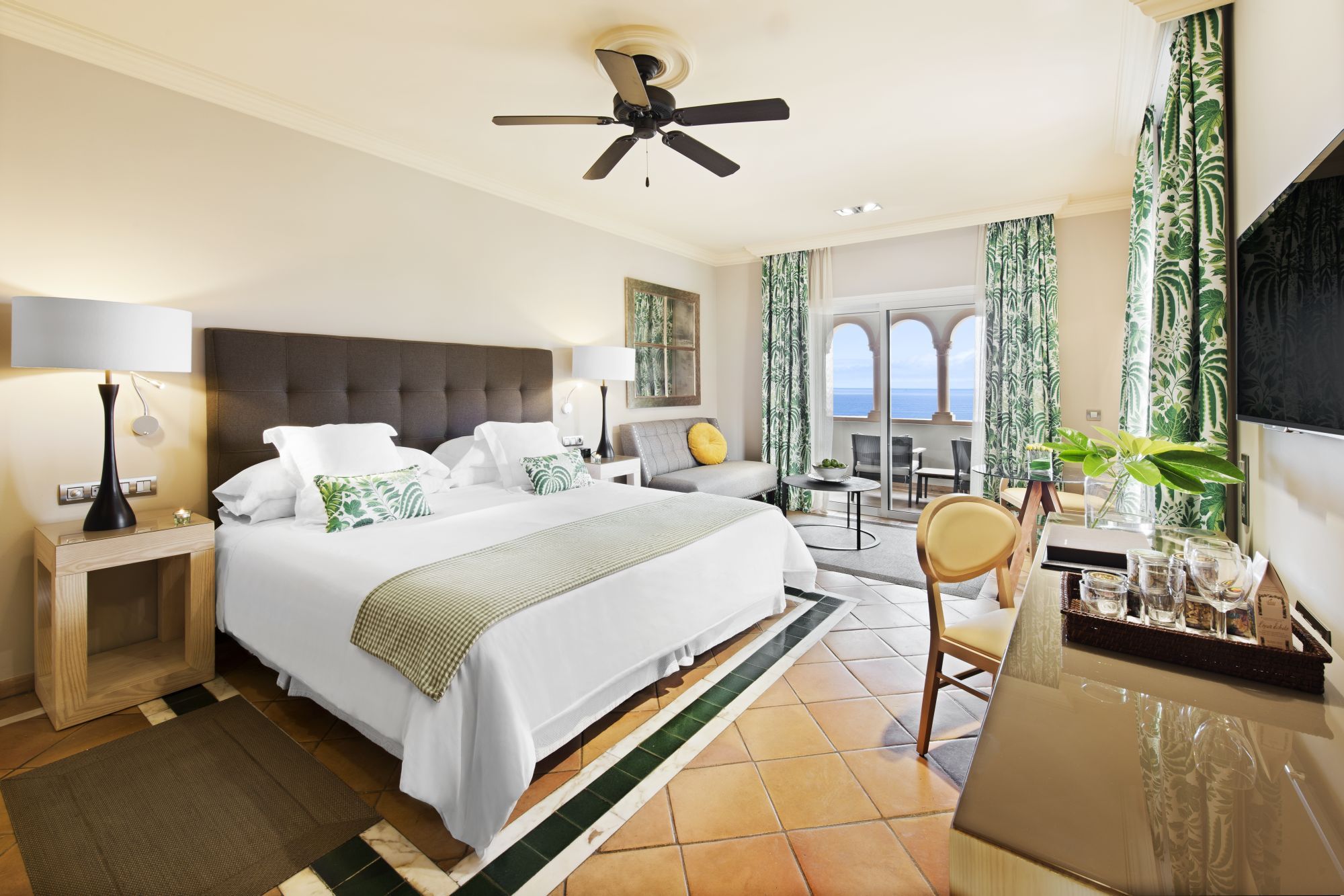 a double bed with white bedspread in Gran Hotel Bahia Del Duque in the Canaries, Spain 