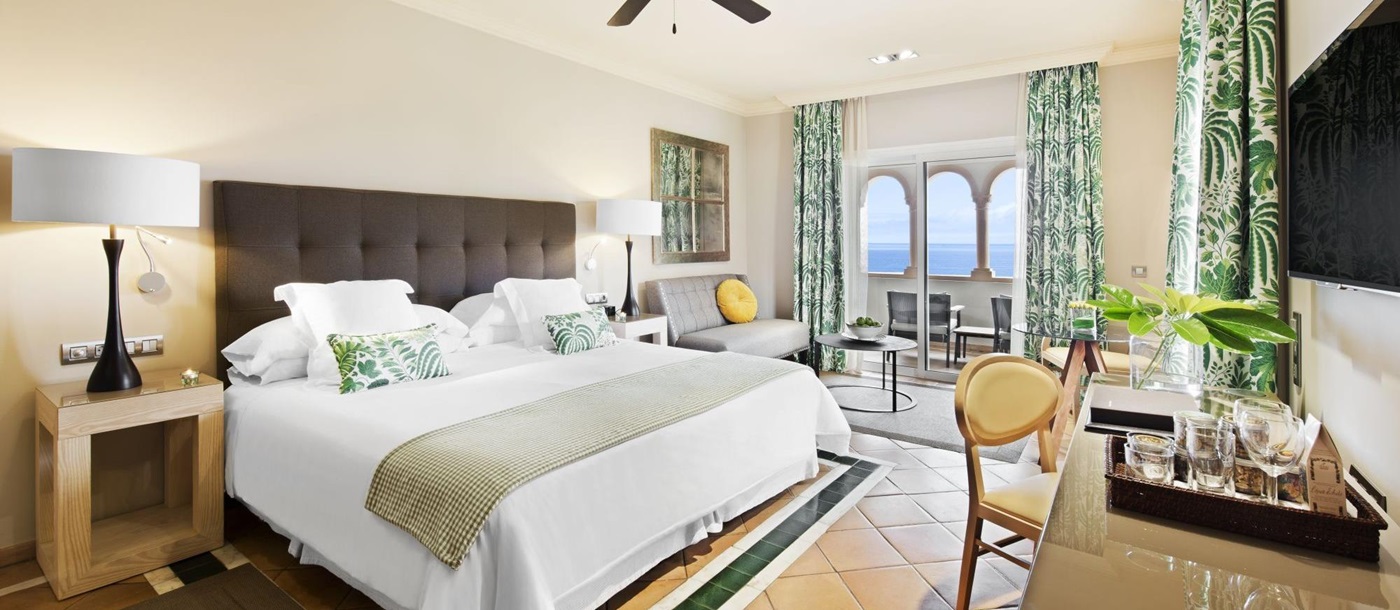 a double bed with white bedspread in Gran Hotel Bahia Del Duque in the Canaries, Spain 