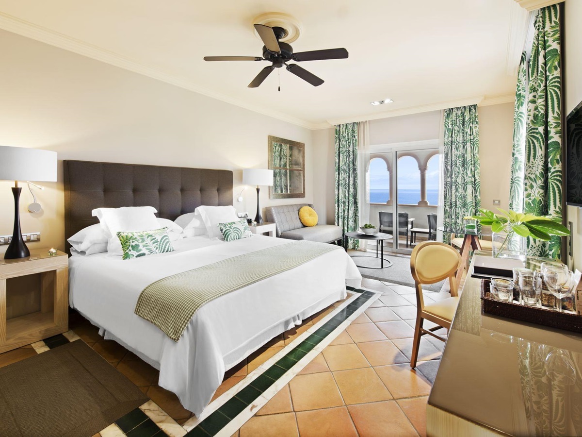 a double bed with white bedspread in Gran Hotel Bahia Del Duque in the Canaries, Spain