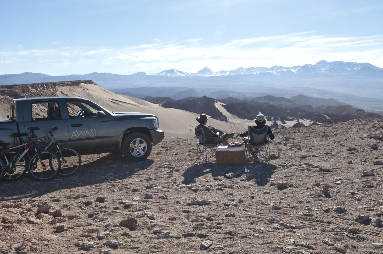 Two people enjoying the view of the mountainous desert