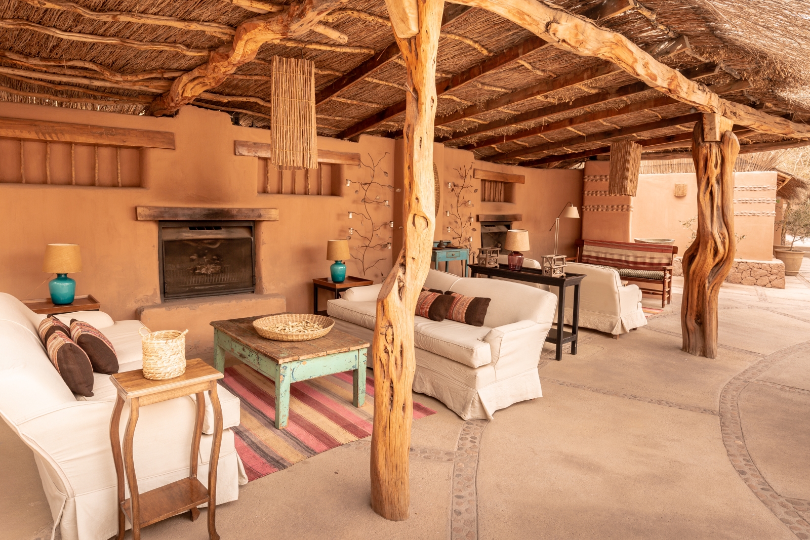 Lounge area with fireplace at Awwasi Atacama
