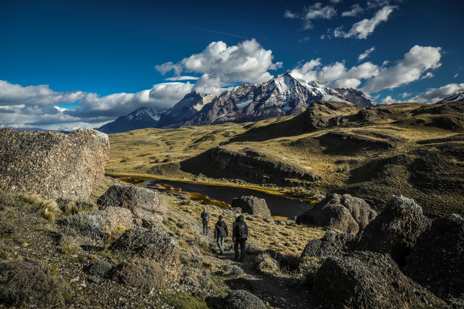 Three hikers walking in the rugged landscape of Patagonia