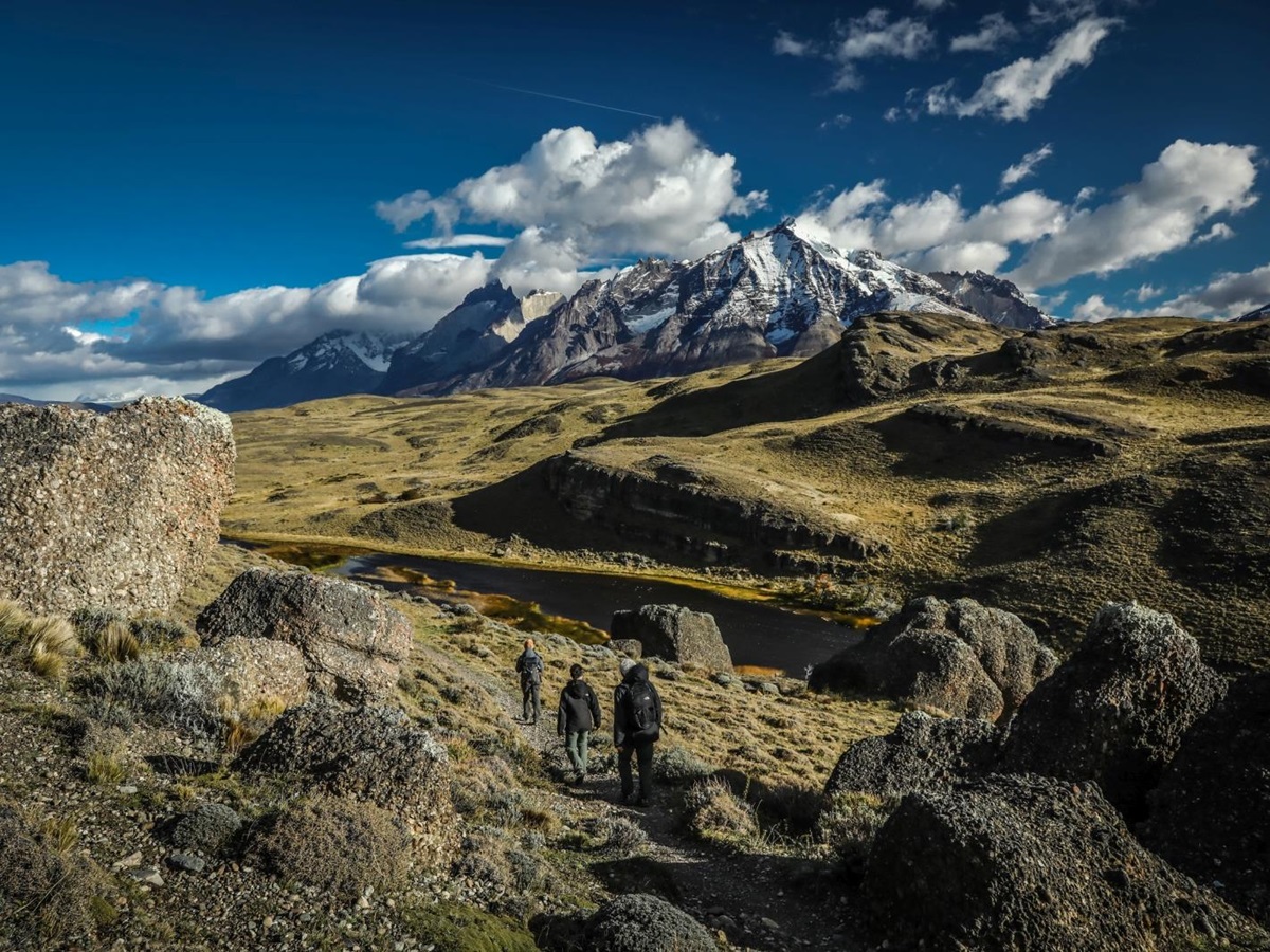Three hikers walking in the rugged landscape of Patagonia