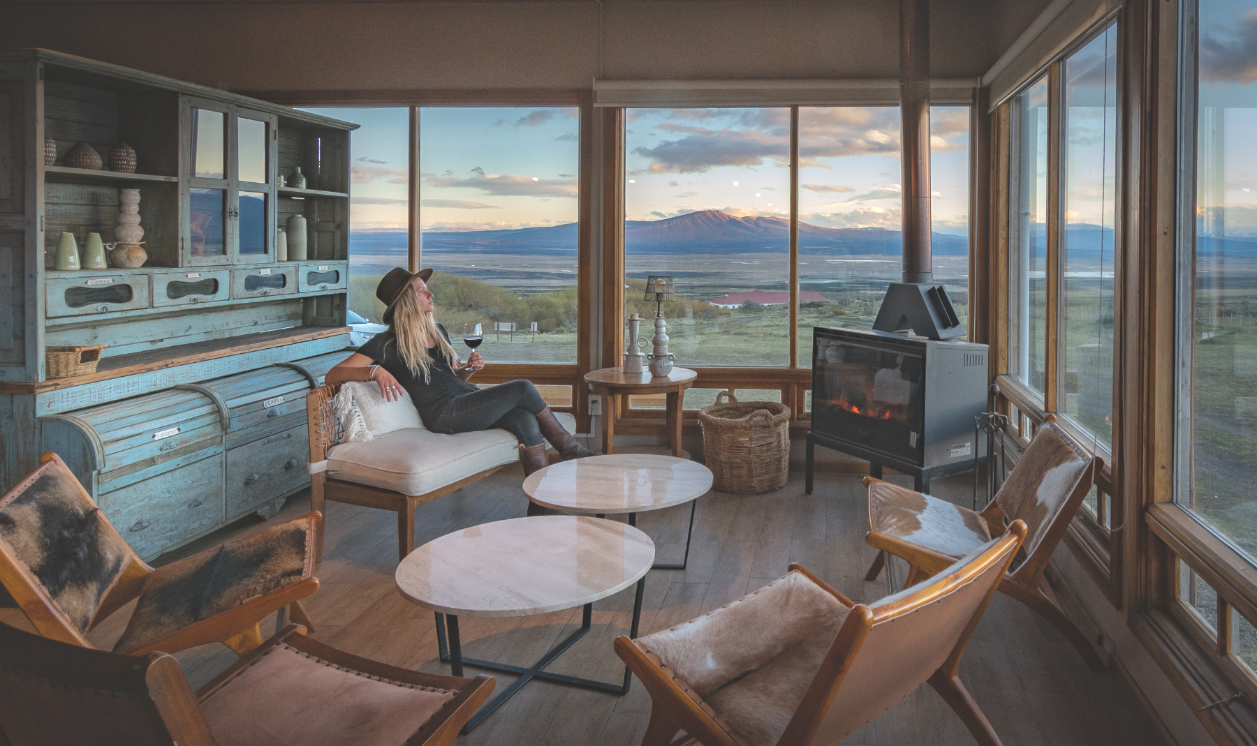 Guest admiring the views over a glass of wine at Estancia Cerro Guido in Patagonia Chile