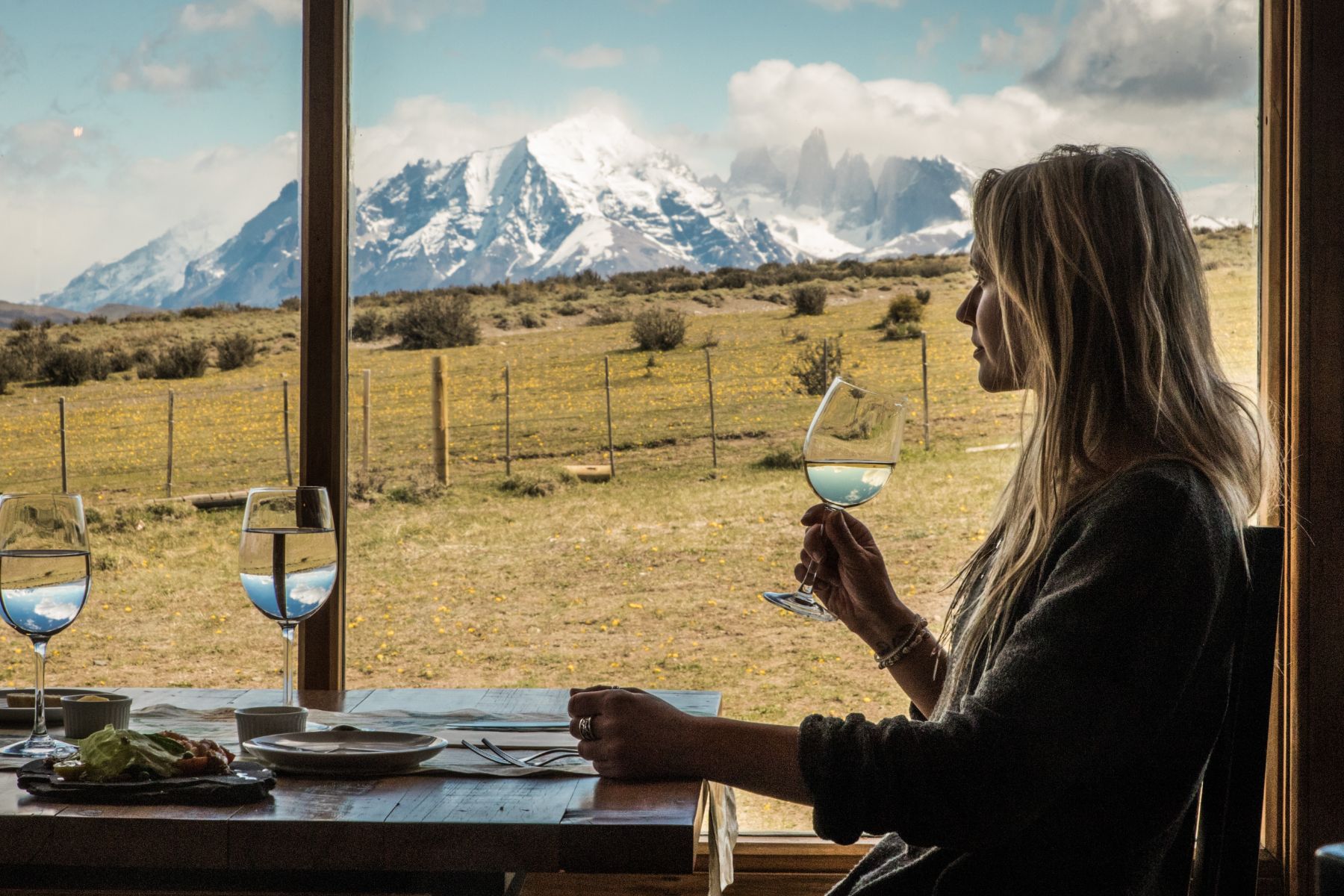 Guest enjoying mountain views from the restaurant at Estancia Cerro Guido in Patagonia Chile