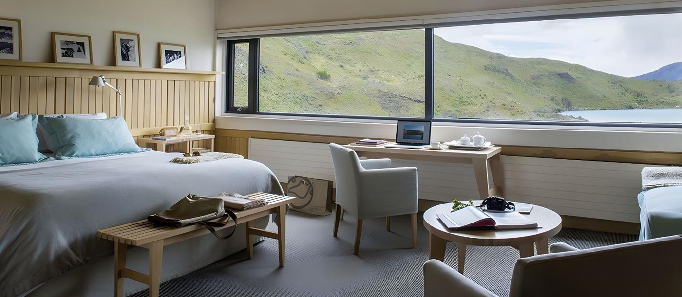 Guest suite bedroom with views of the National Park at Explora Torres del Paine in Chile