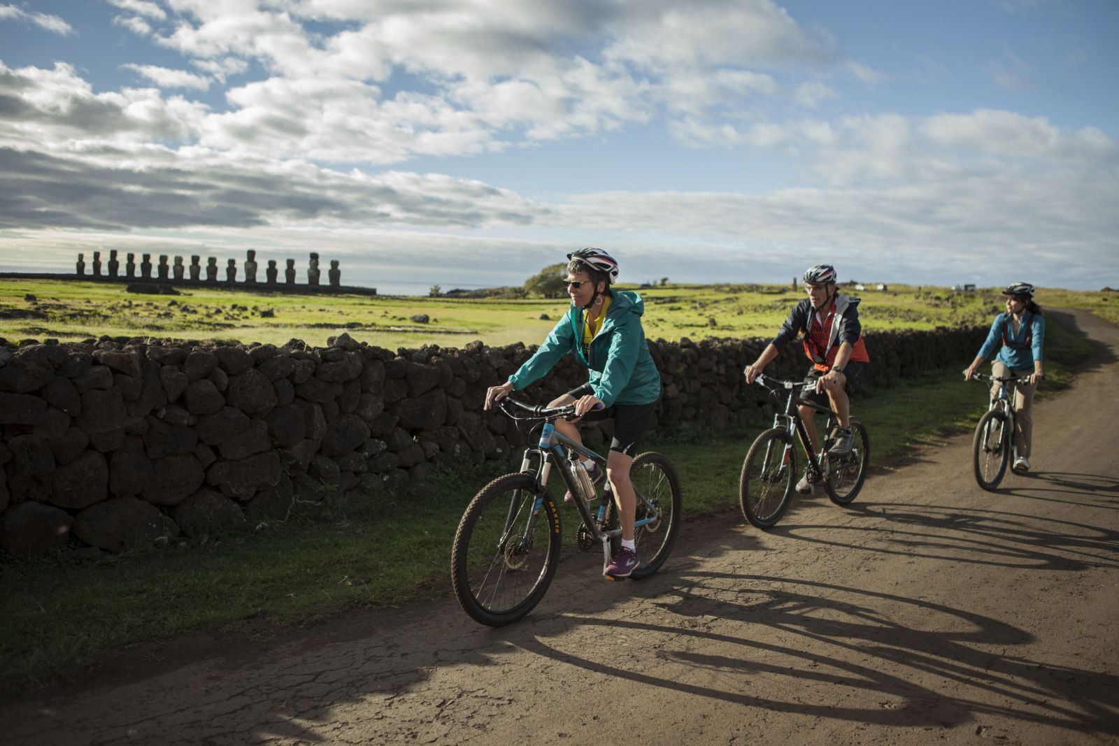 Bike riding past Moai statues on Easter Island, Explora Rapa Nui