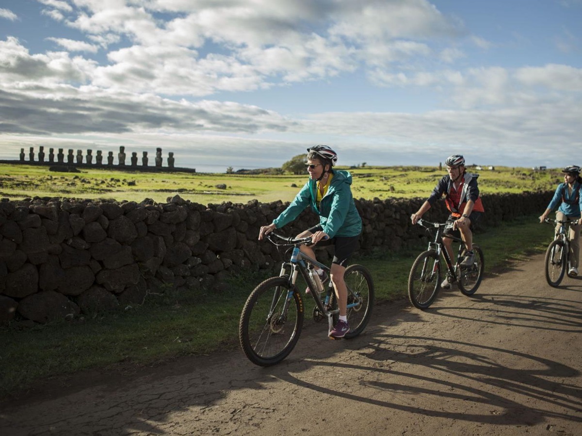Bike riding past Moai statues on Easter Island, Explora Rapa Nui