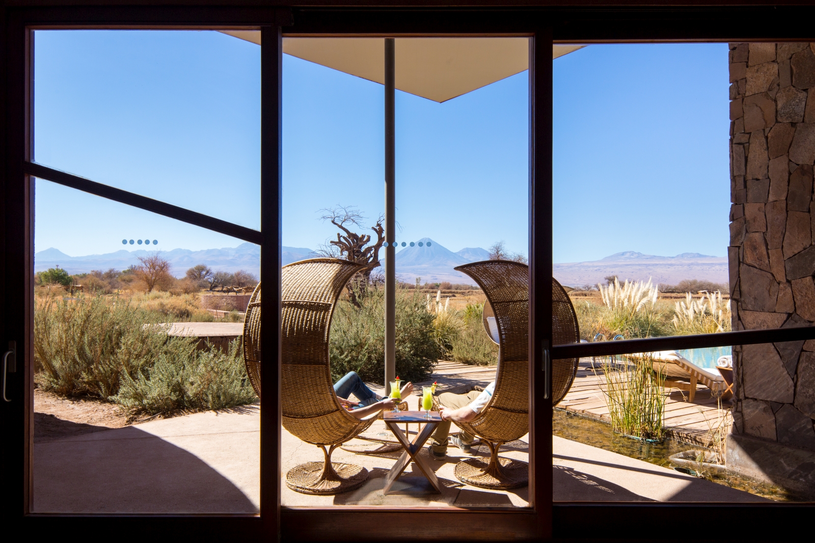 Two big chairs on a terrace overlooking the landscape and mountains