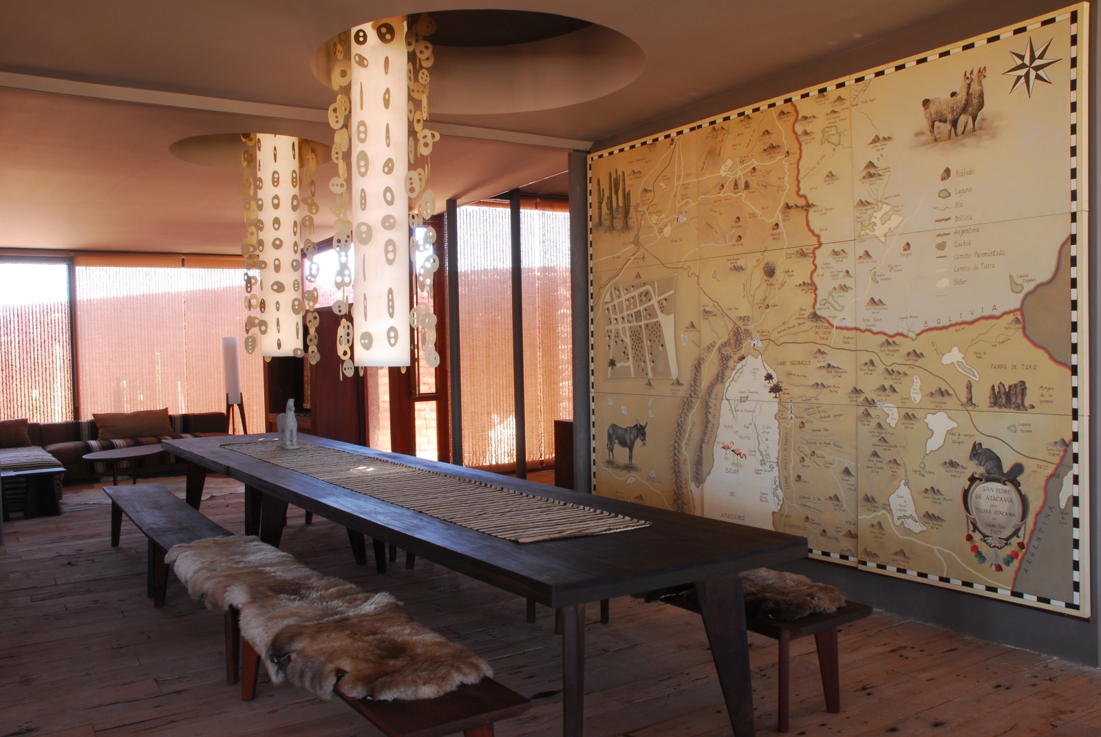 Long dining table in front of a big wall-covering map