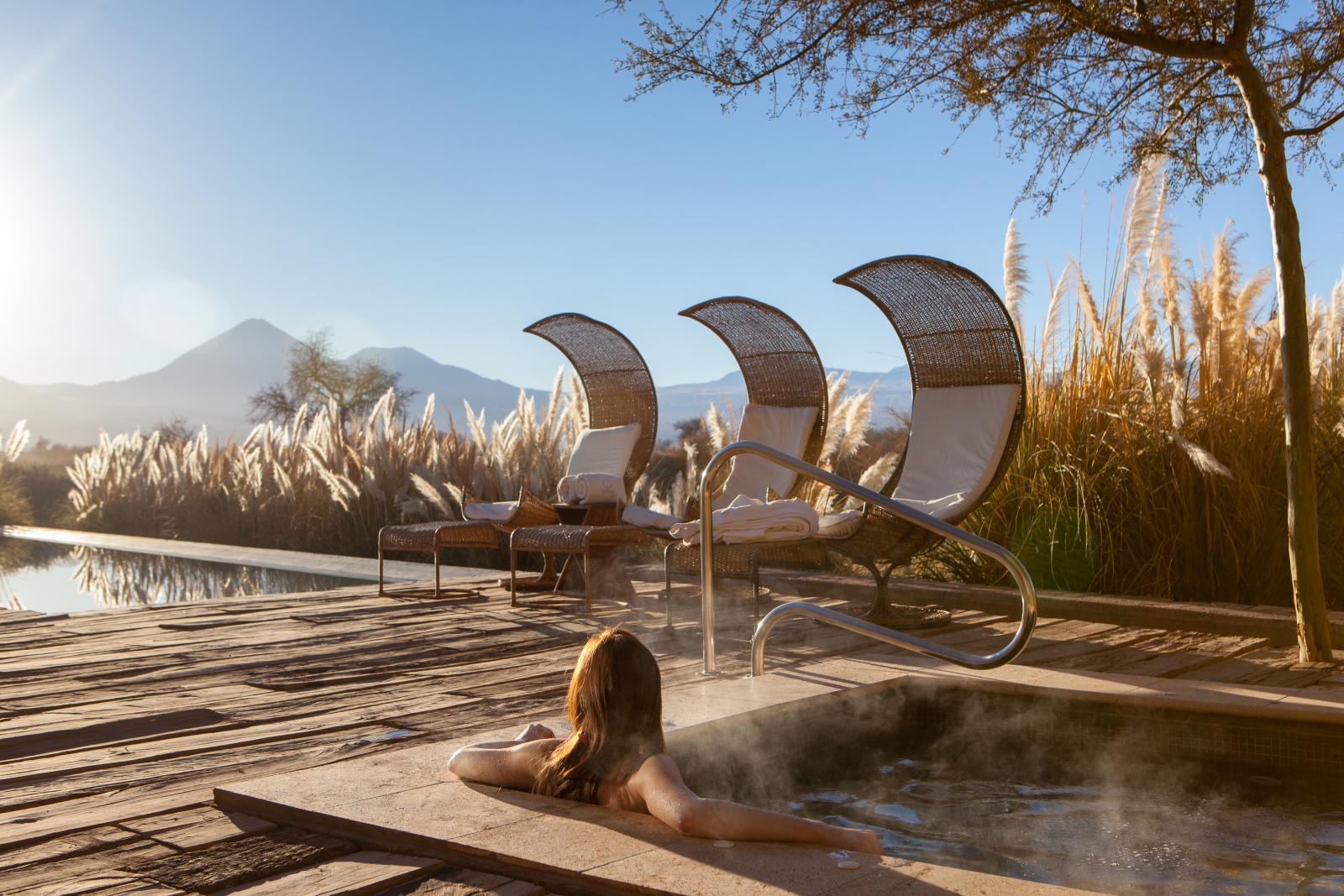 Woman enjoying the jacuzzi overlooking the mountains at Tierra atacama