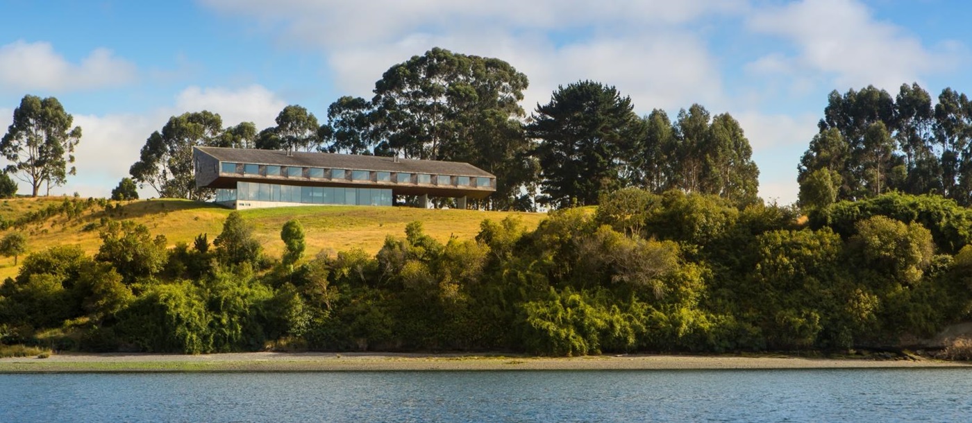 Exterior view of Tierra Chiloe on a hill overlooking a lake