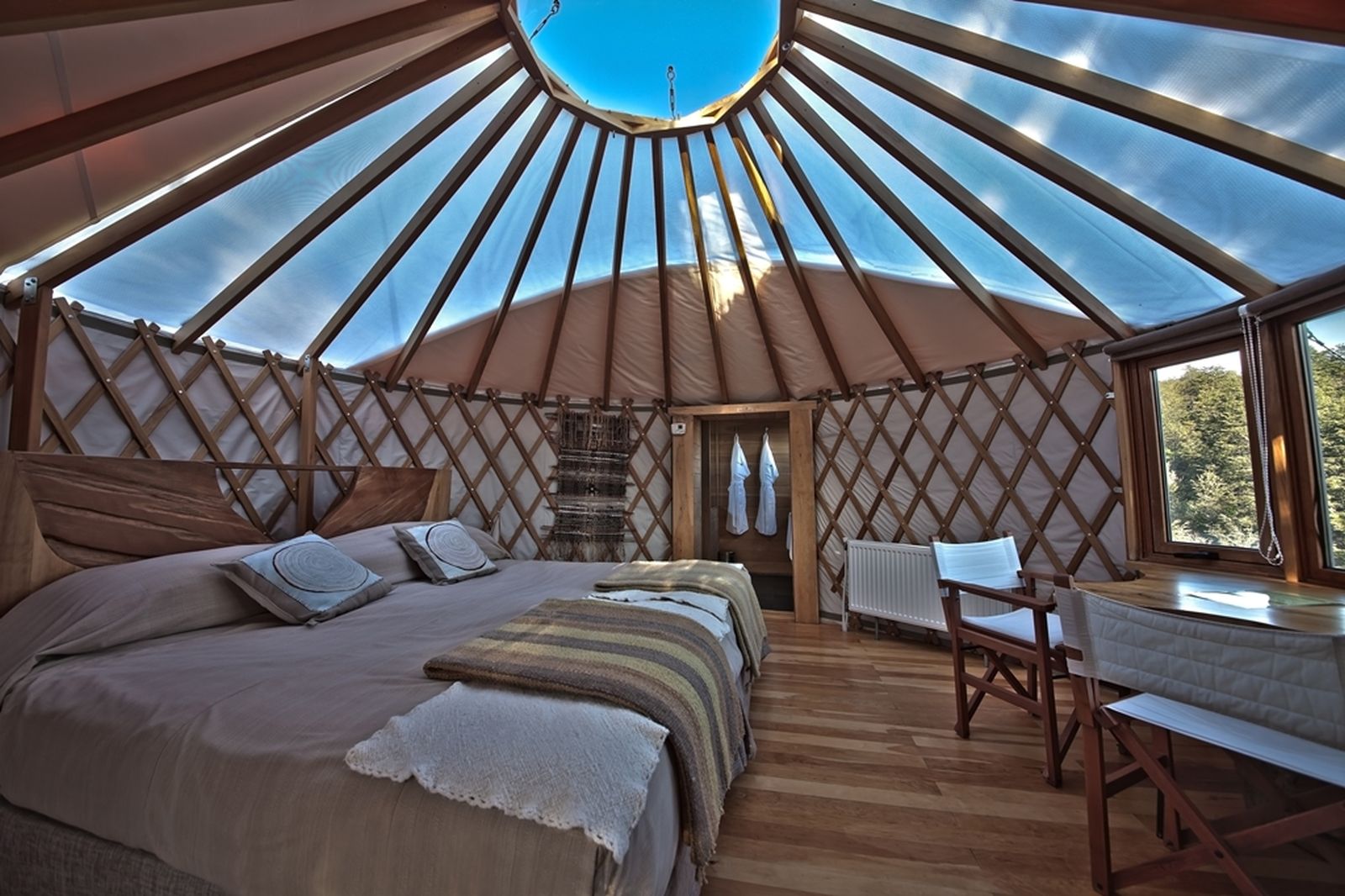 Interior of one of the luxury yurts at Patagonia Camp Chile with clear domed ceiling to see the sky
