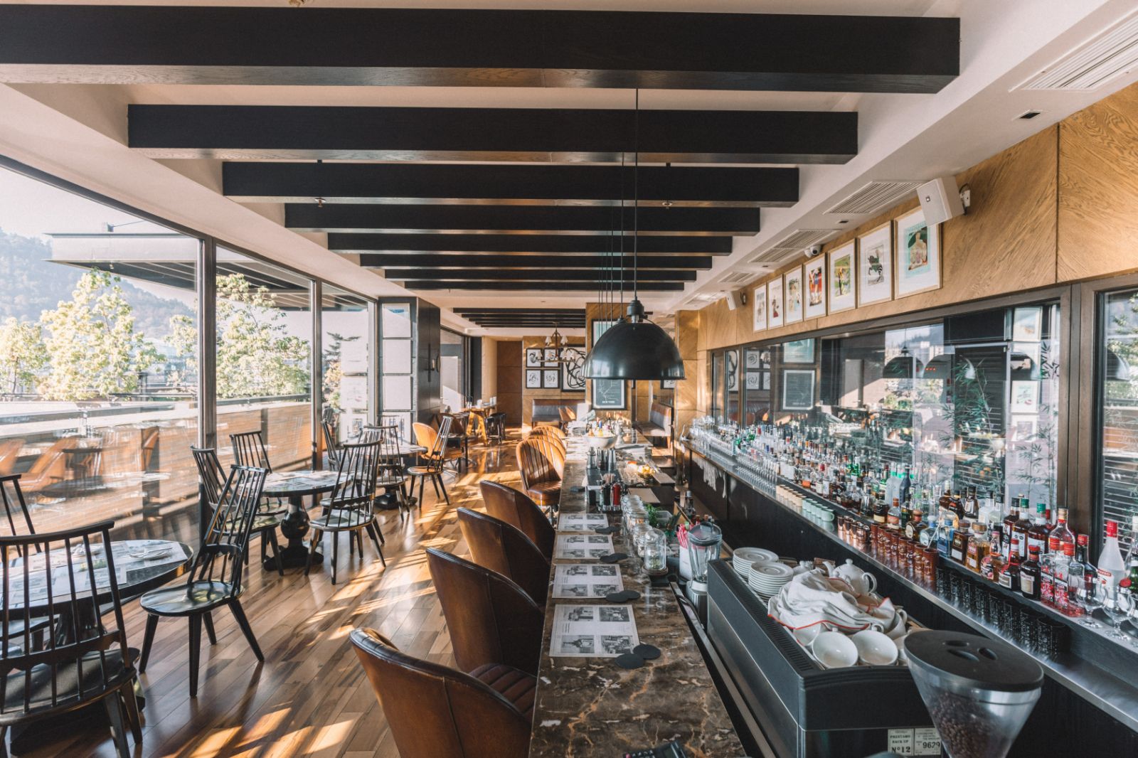 Rooftop bar terrace with floor-to-ceiling windows at The Singular Santiago hotel, Chile