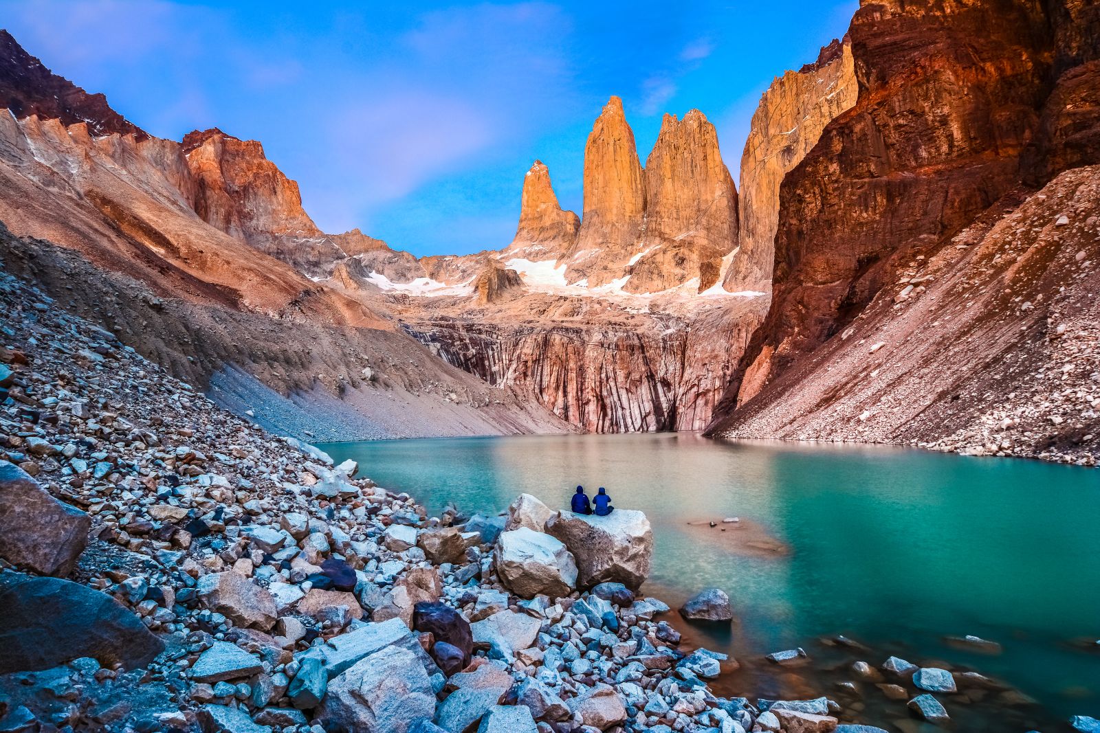 A couple looking out to the Base of the Towers inn Torres del Paine Patagonia Chile