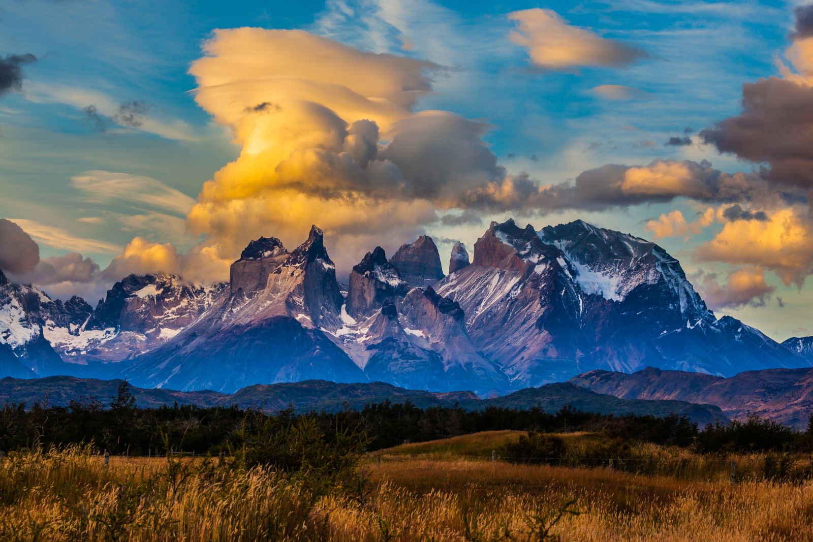 Orange clouds over the Torres del Paine cuernos or horns in Patagonia, Chile