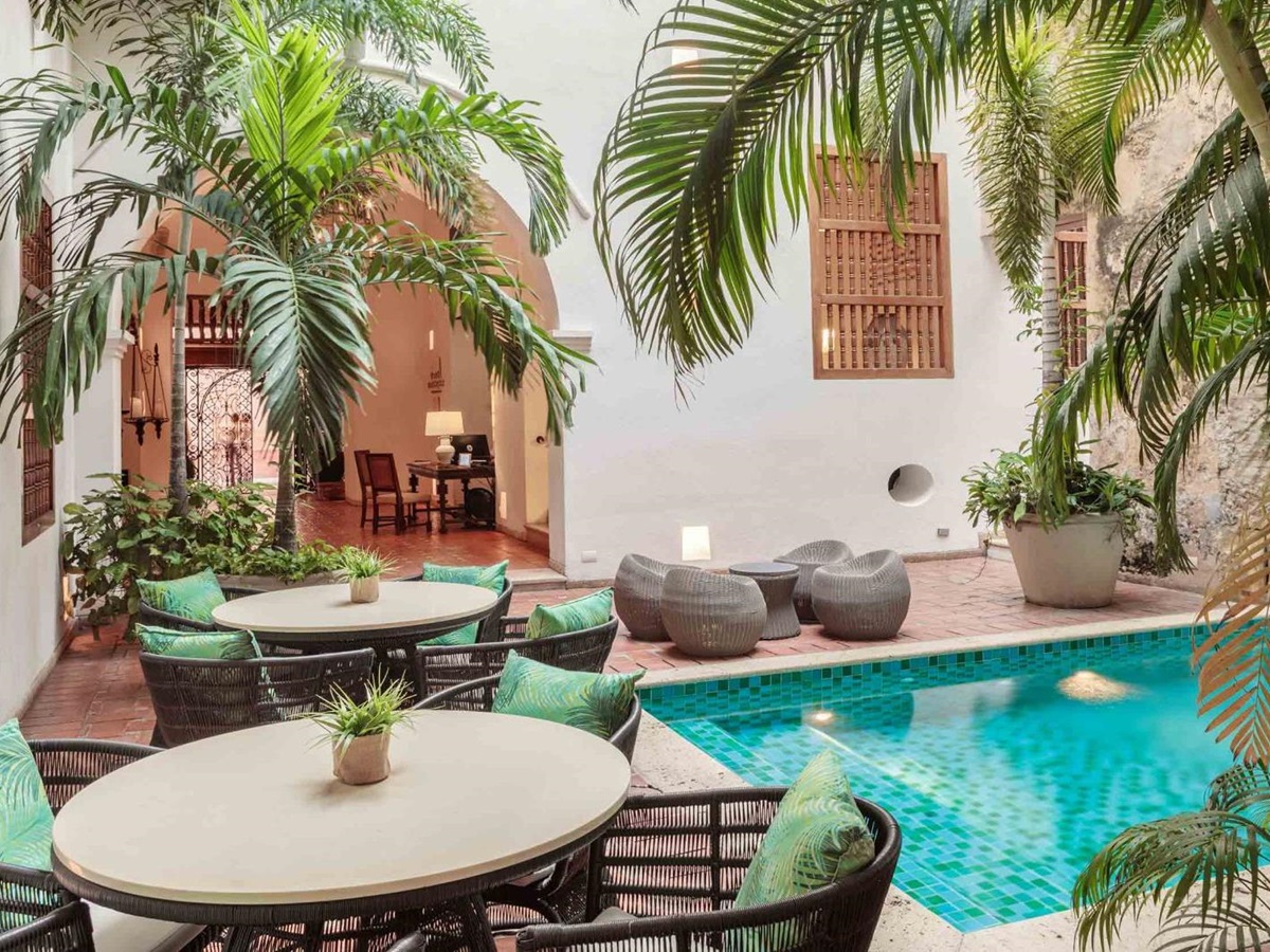 Pool and small dining tables at Casa San Agustin in Cartagena, Colombia