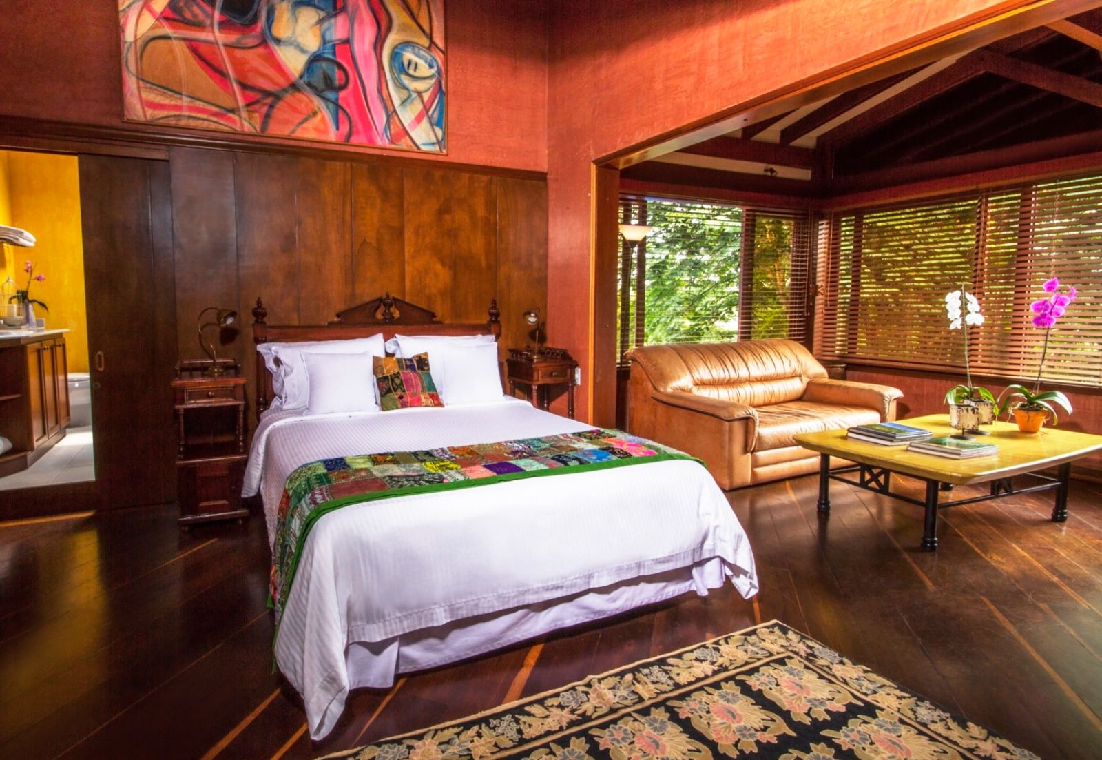 Red guest suite with double bed at Hotel Boutique Sazagua in Colombia's coffee region