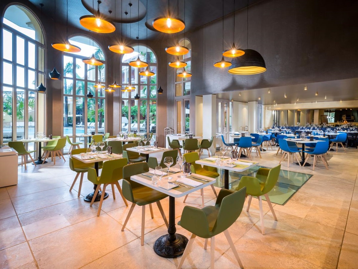 Green restaurant seating area at Sofitel Legend Santa Clara in Cartagena, Colombia