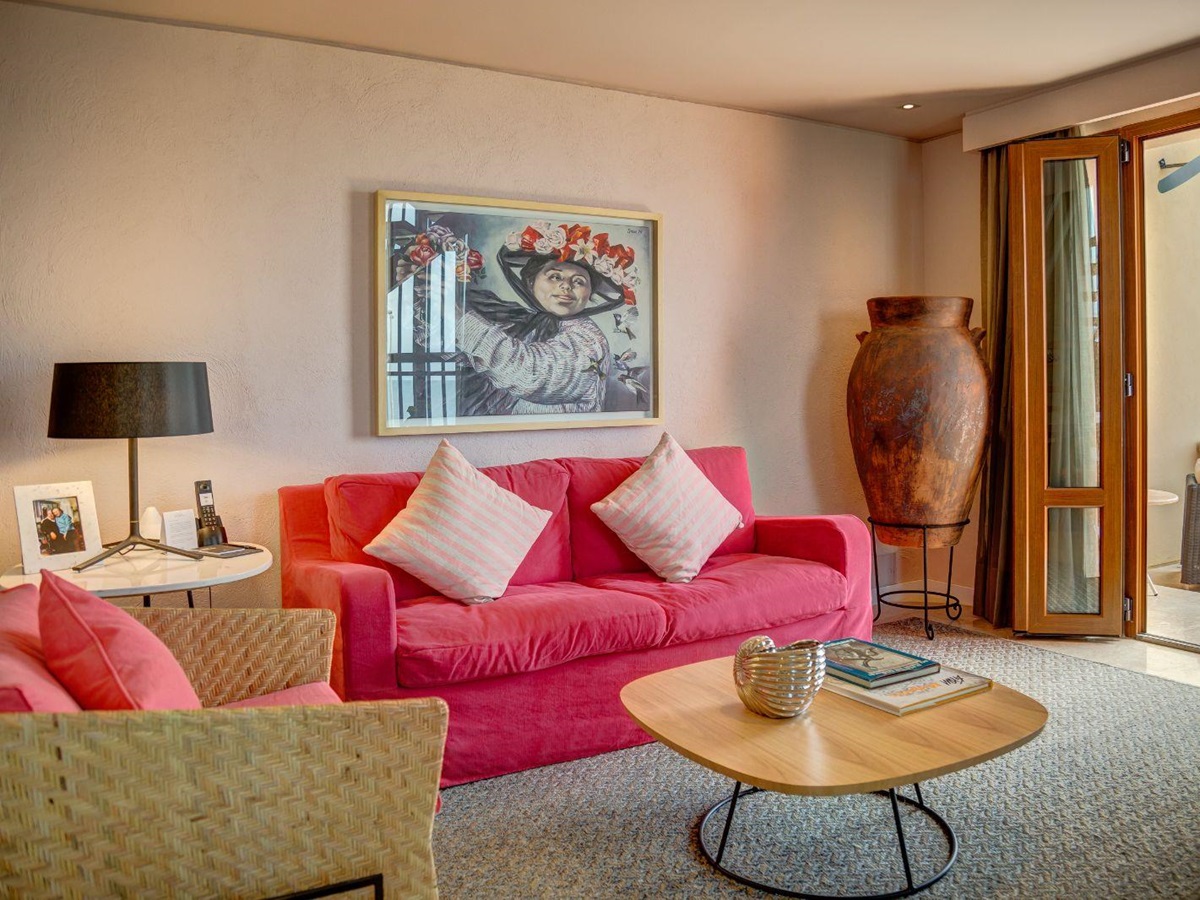 Red guest suite living area at Sofitel Legend Santa Clara in Cartagena, Colombia