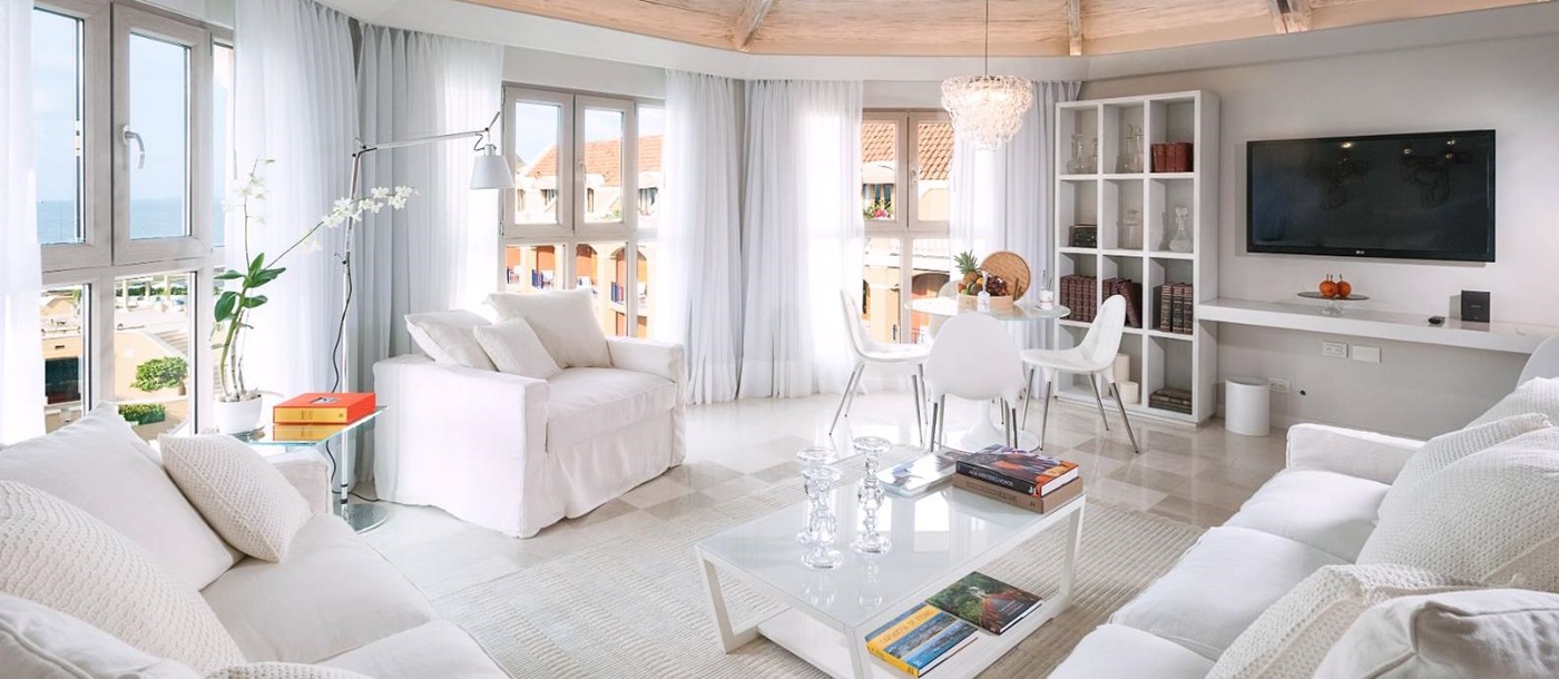 White guest suite living area at Sofitel Legend Santa Clara in Cartagena, Colombia