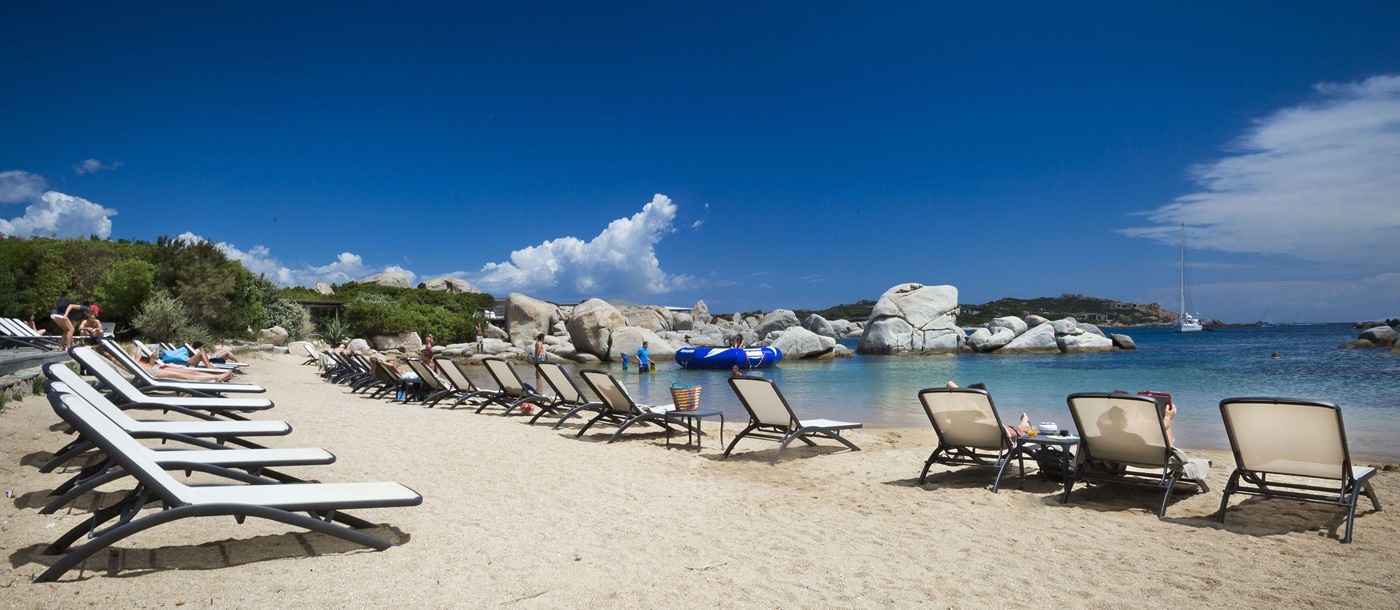 sunbeds on the beach at Hotel  & Spa des Pecheurs, Corsica, France