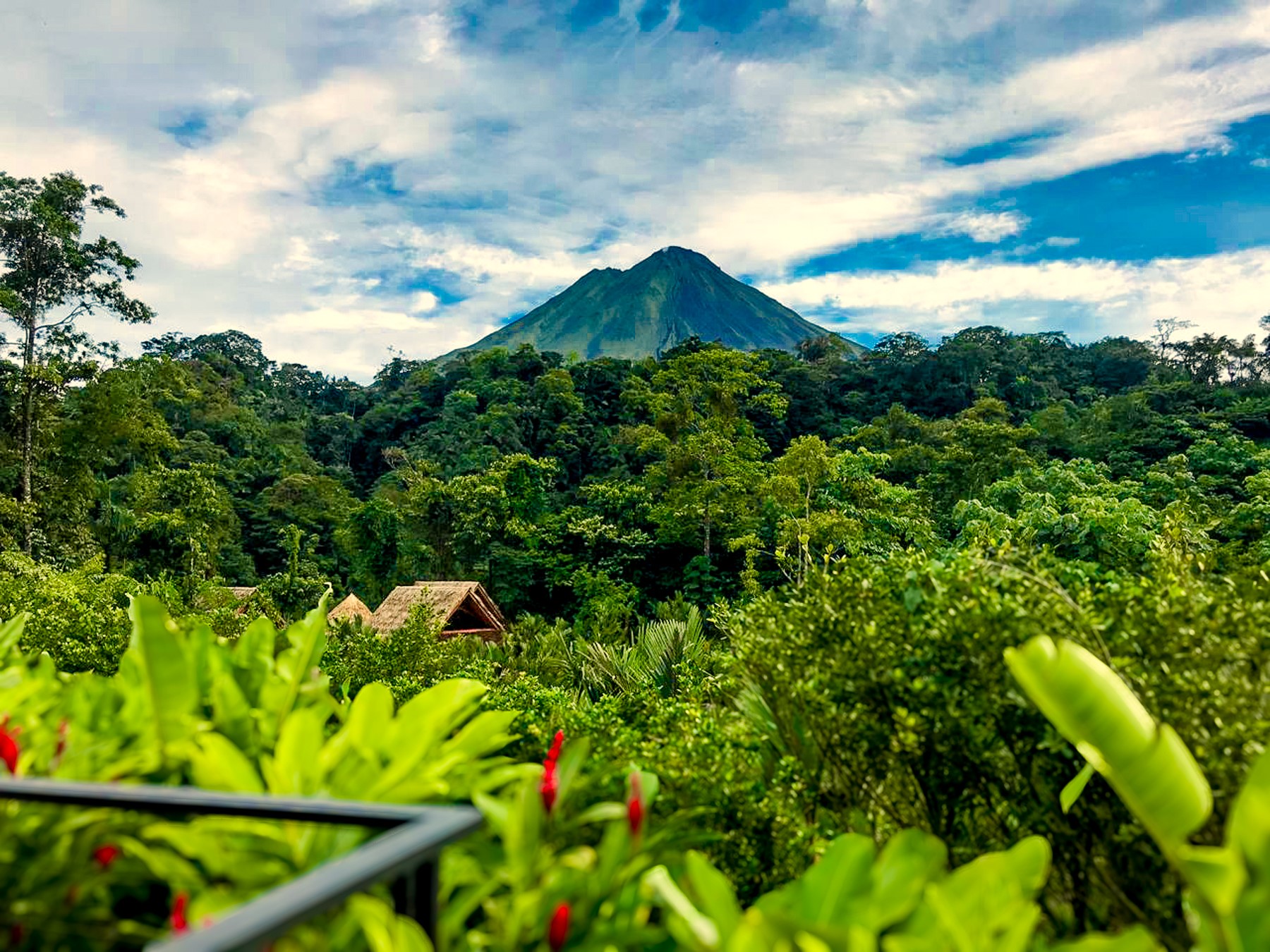 View of Arenal Volcano from a canyon casita deck at Amor Arenal in Costa Rica