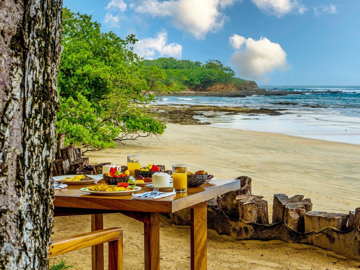A table set up for private dining on the beach at Capitan Suizo in Tamarindo