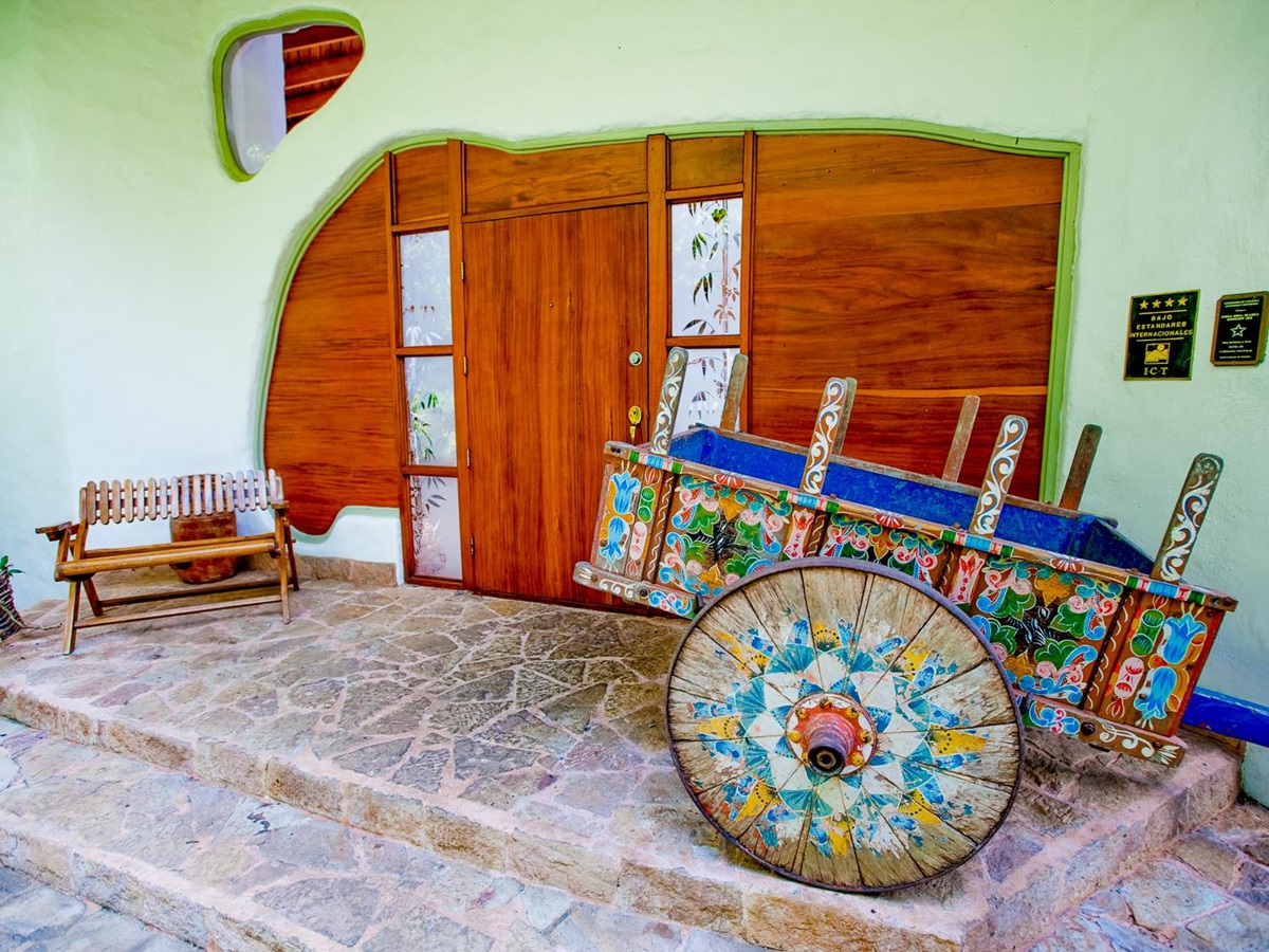 A colourful wagon outside a suite at Finca Rosa Blanca