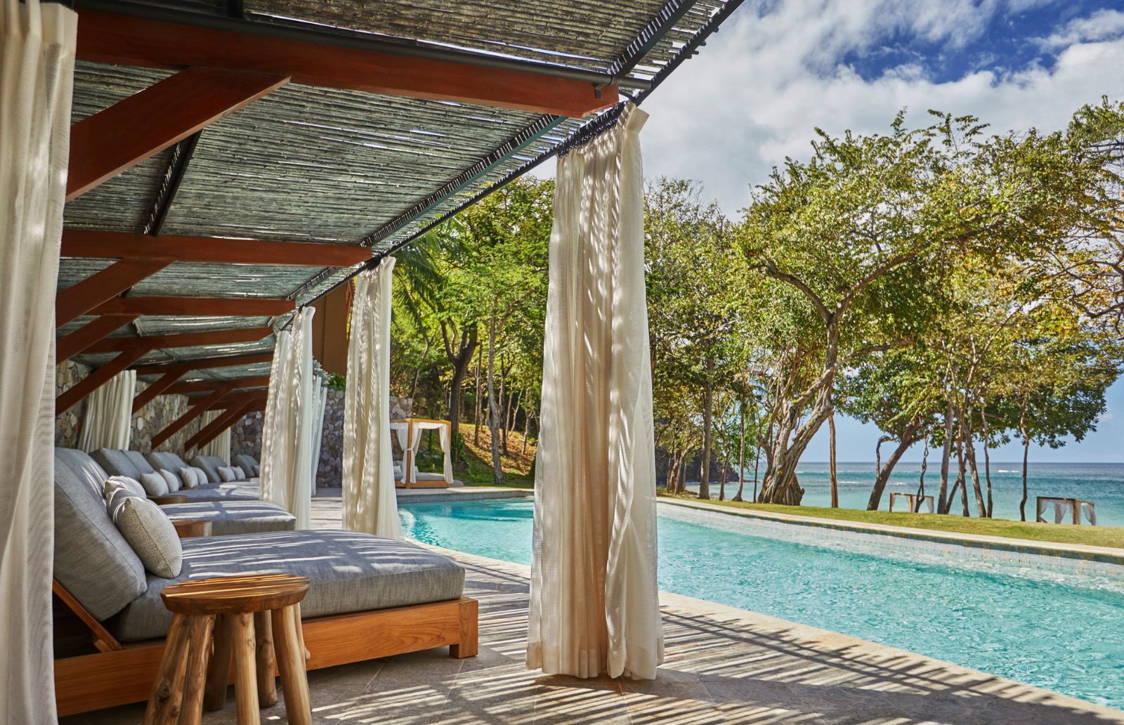 Loungers by the pool at Four Seasons Costa Rica on the Papagayo Peninsula