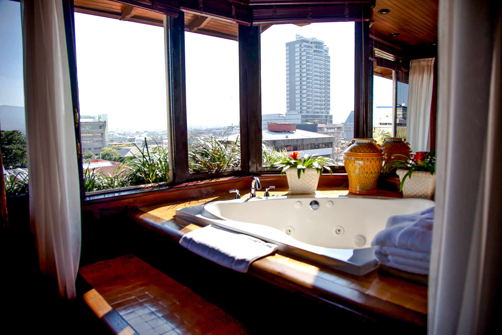 Vista de Oro suite bathroom overlooking the city at Hotel Grano de Oro in San Jose