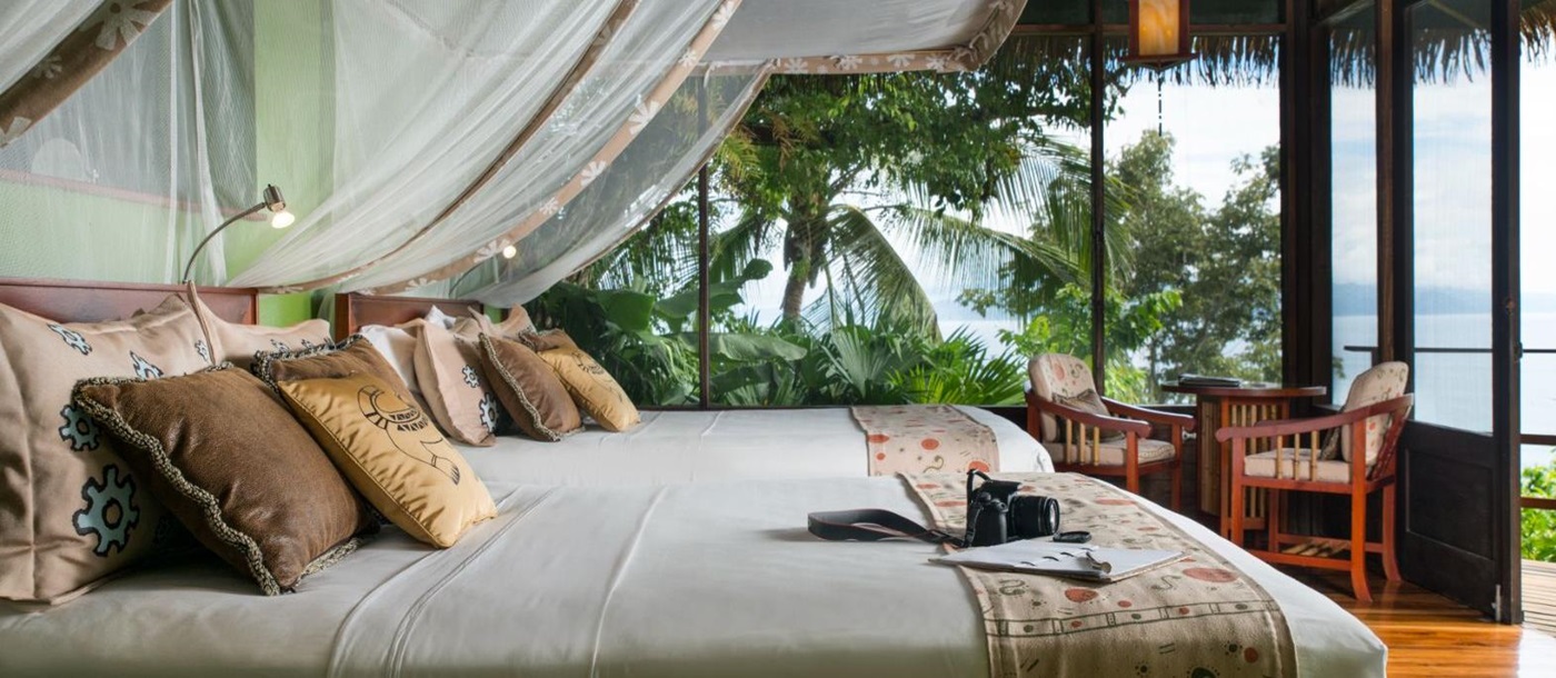 Villa guest suite bed at Lapa Rios resort in Costa Rica