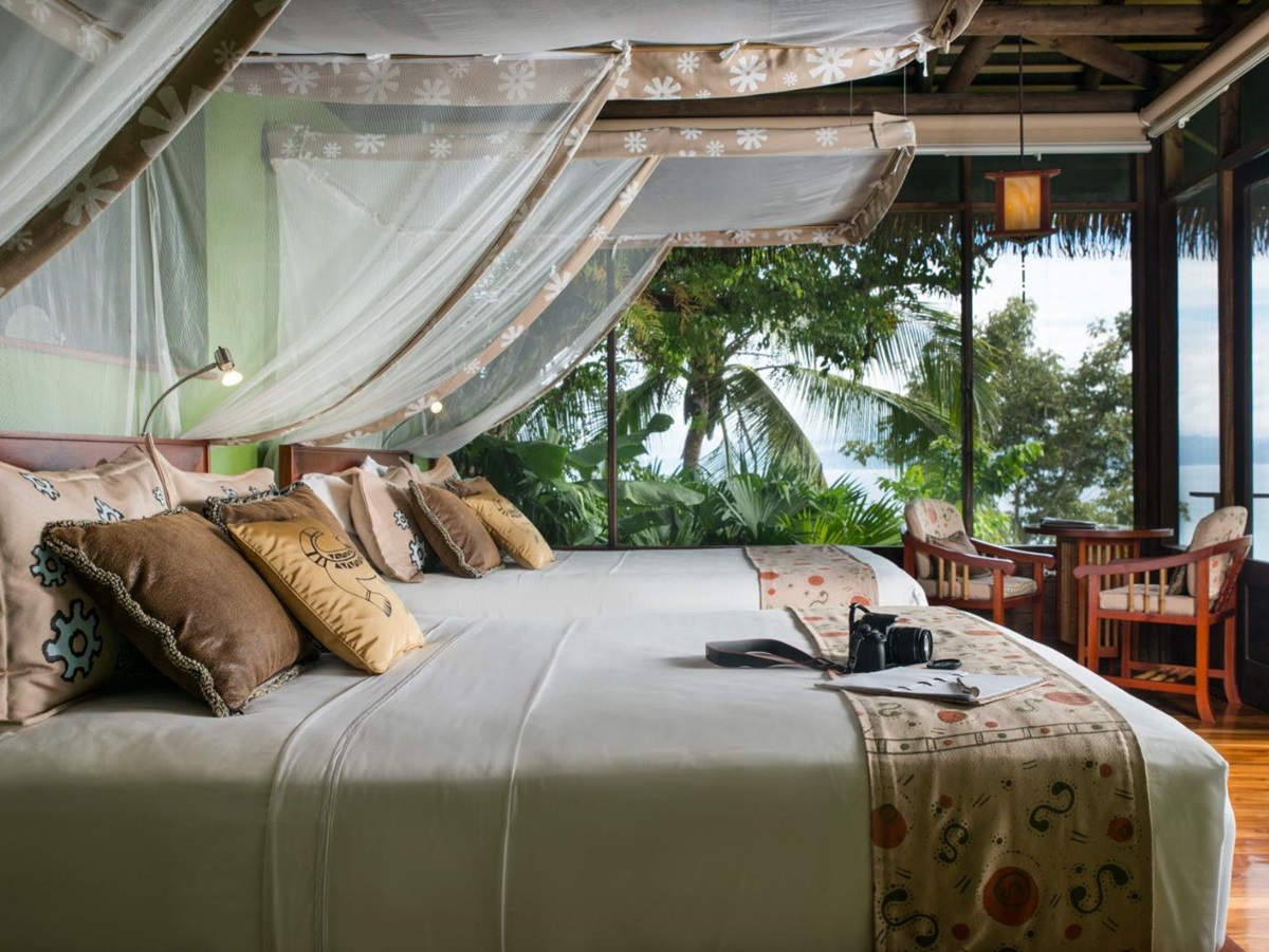 Villa guest suite bed at Lapa Rios resort in Costa Rica