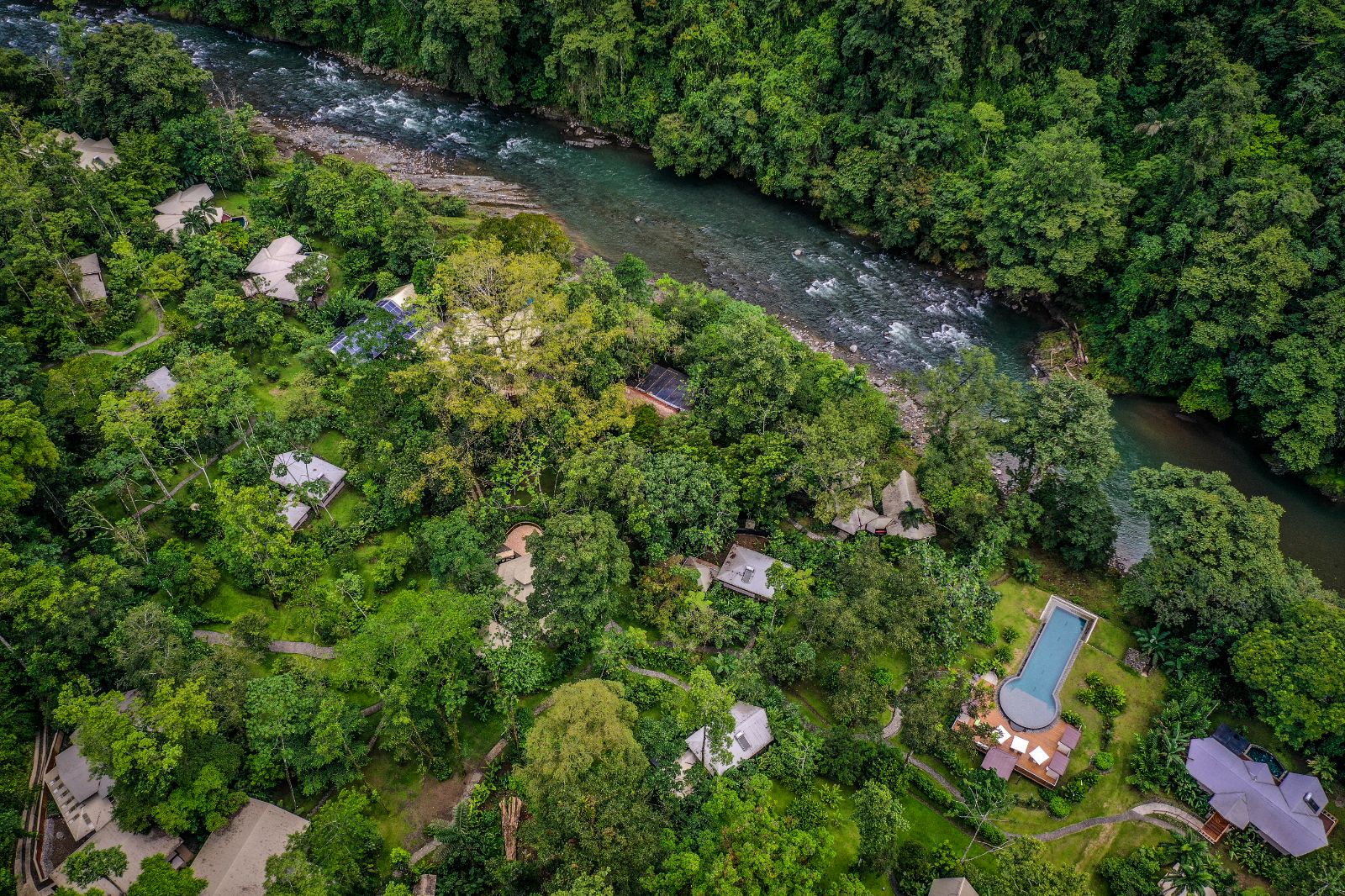 Exterior view of Pacuare Lodge set in lush green rainforest in Costa Rica 