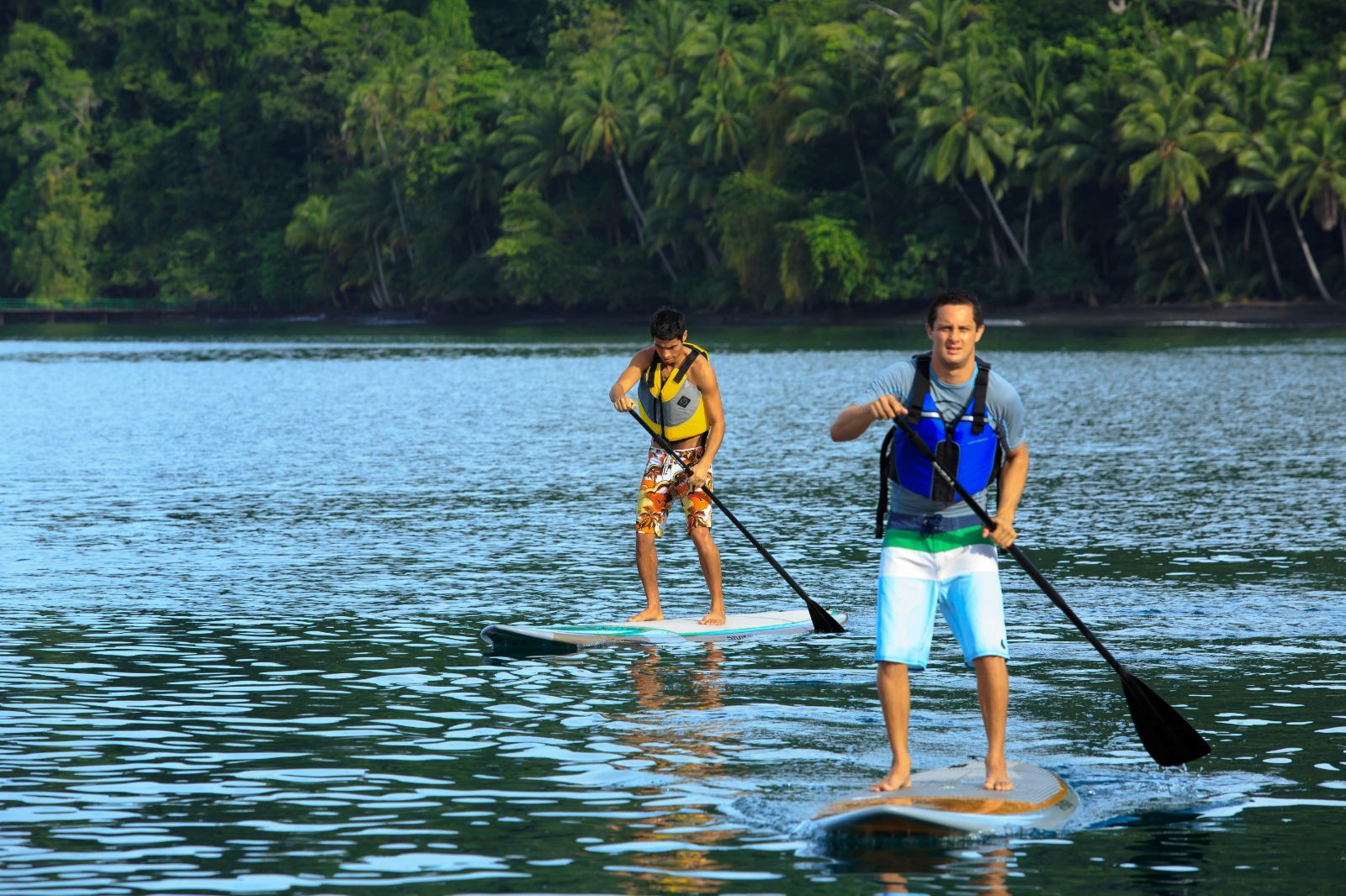 A family paddleboarding at Playa Cativo in Costa Rica