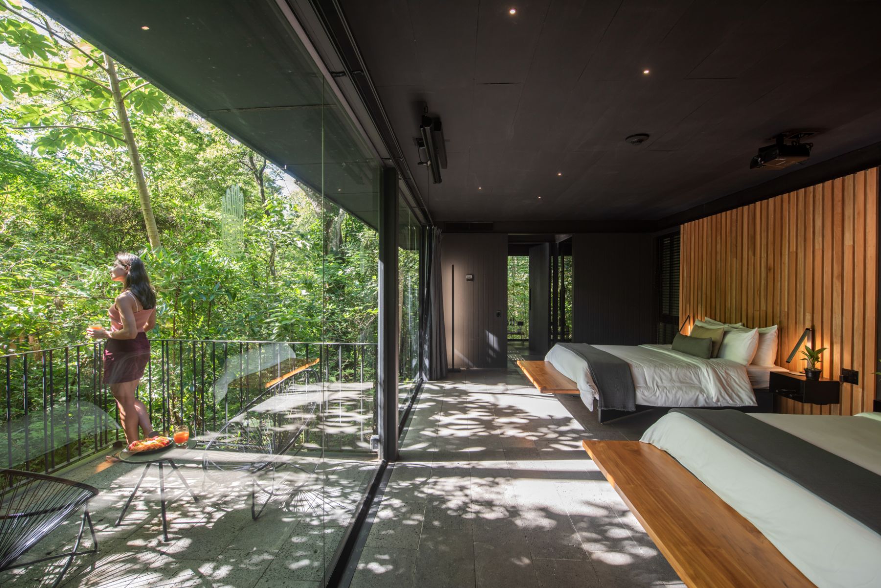 Guest enjoying forest views from bungalow terrace at Rio Perdido in Costa Rica