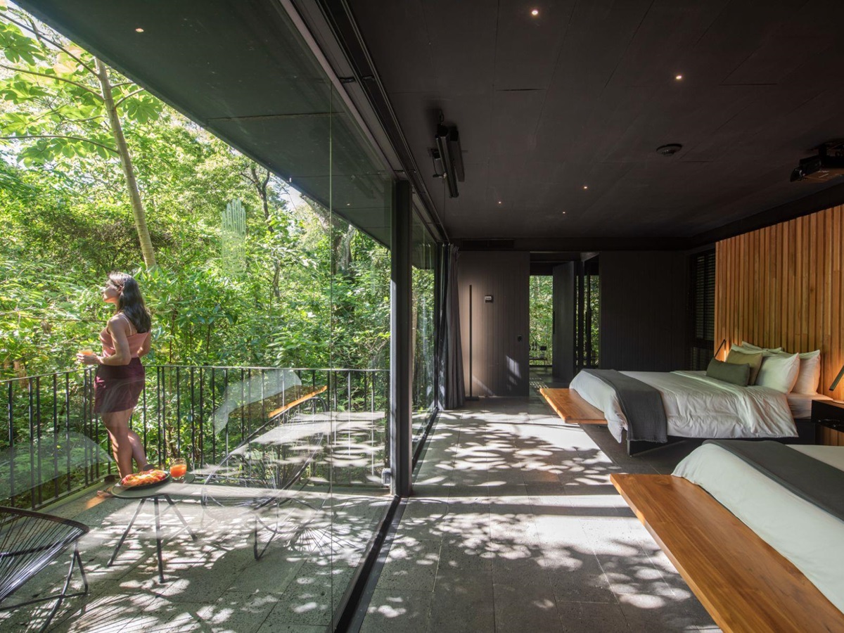 Guest enjoying forest views from bungalow terrace at Rio Perdido in Costa Rica