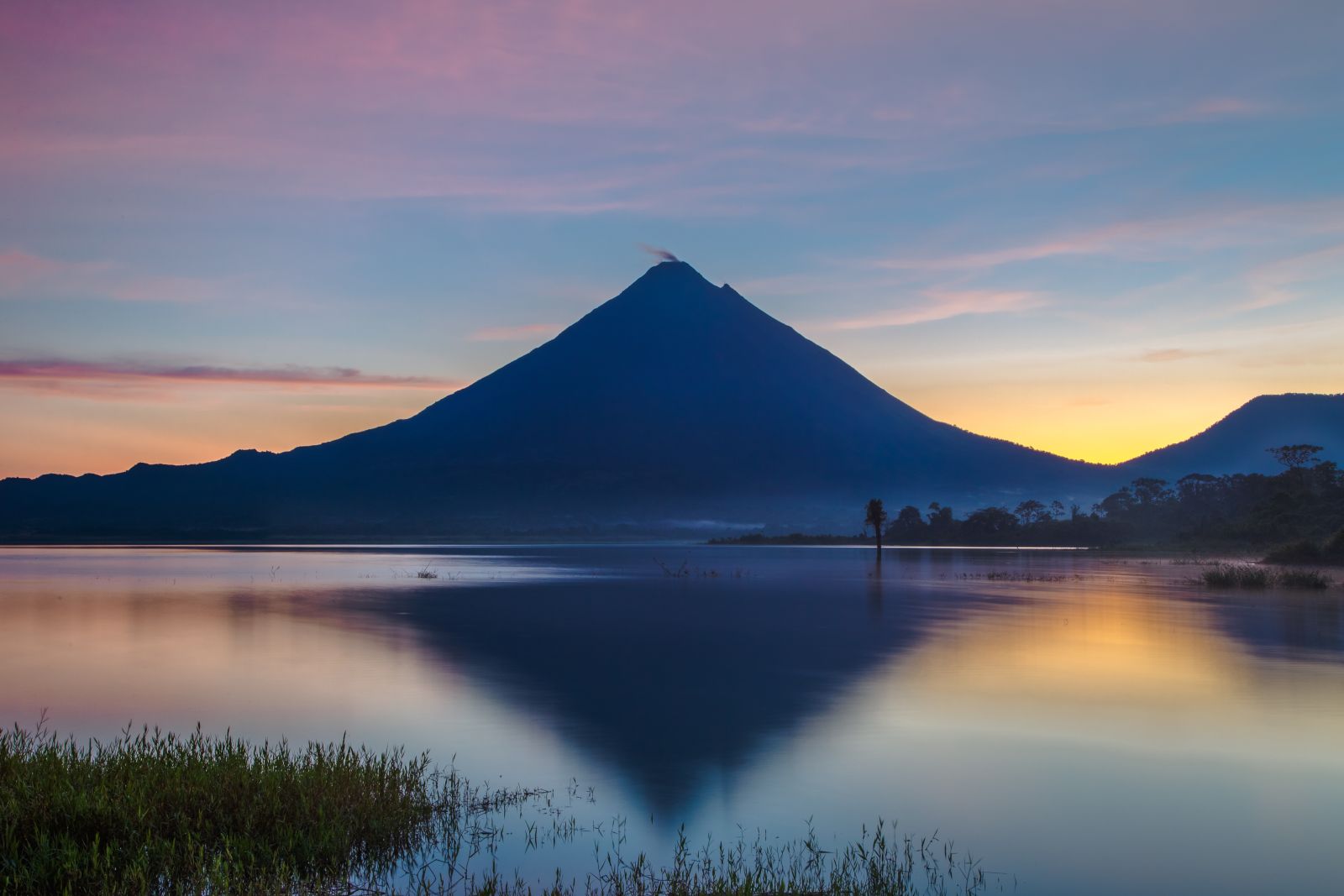 Reflection of the Arenal Volcano on Lake Arenal at sunrise
